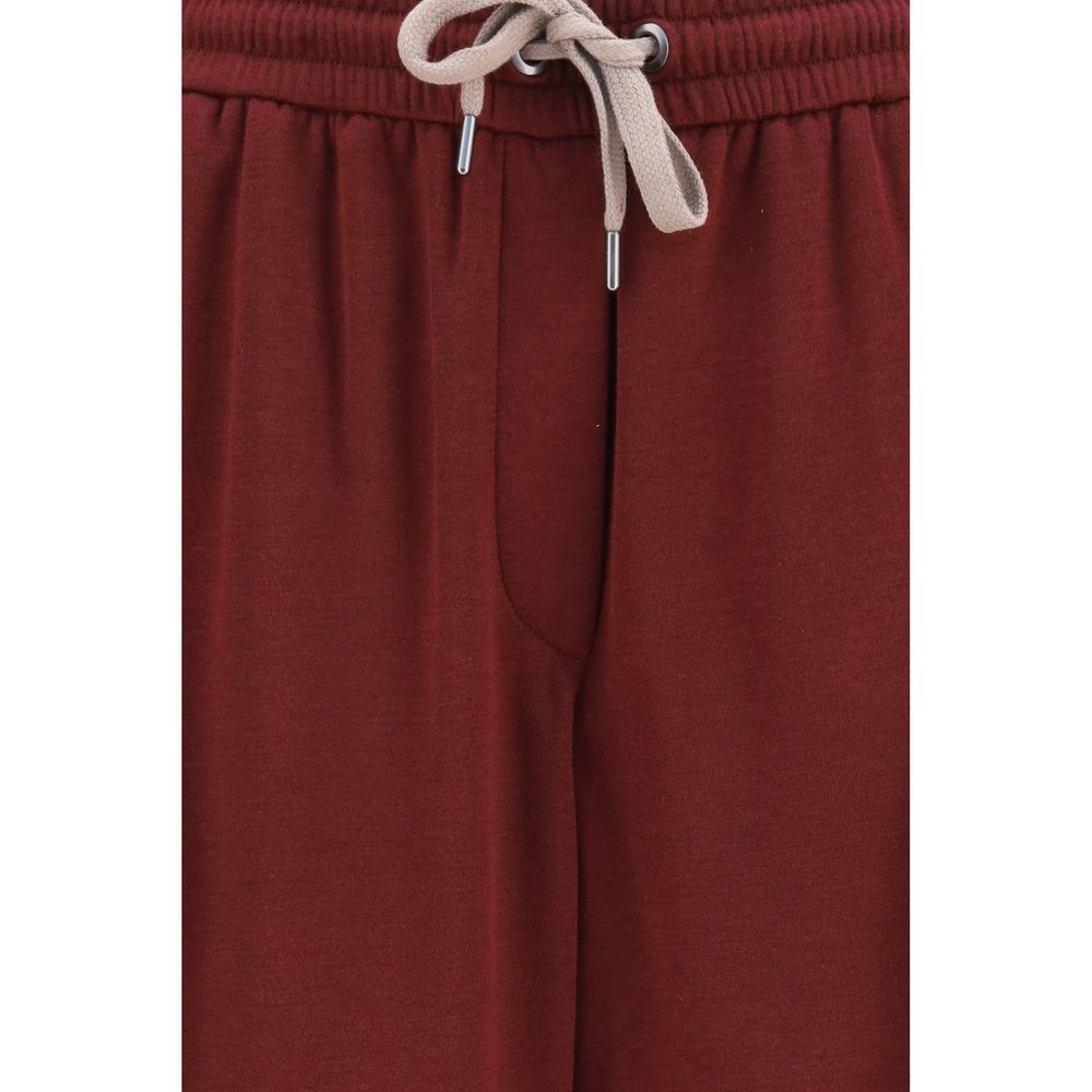 Experience the exquisite allure of Brunello Cucinelli Bordeaux Cotton Athletic Pants, crafted from a luxurious cotton-silk blend for unparalleled elegance and comfort.