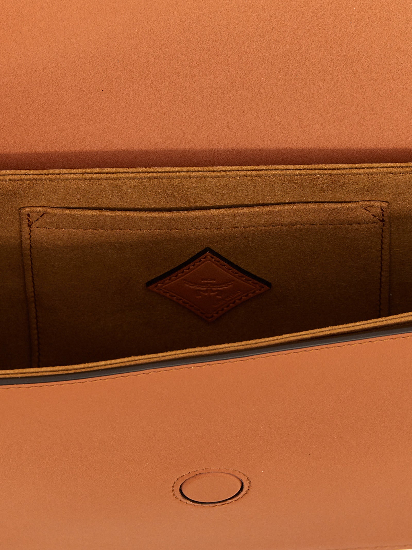 Discover the MCM Brown Calfskin Crossbody Bag, a masterpiece of Italian craftsmanship in luxurious leather, embodying timeless elegance for the discerning individual.