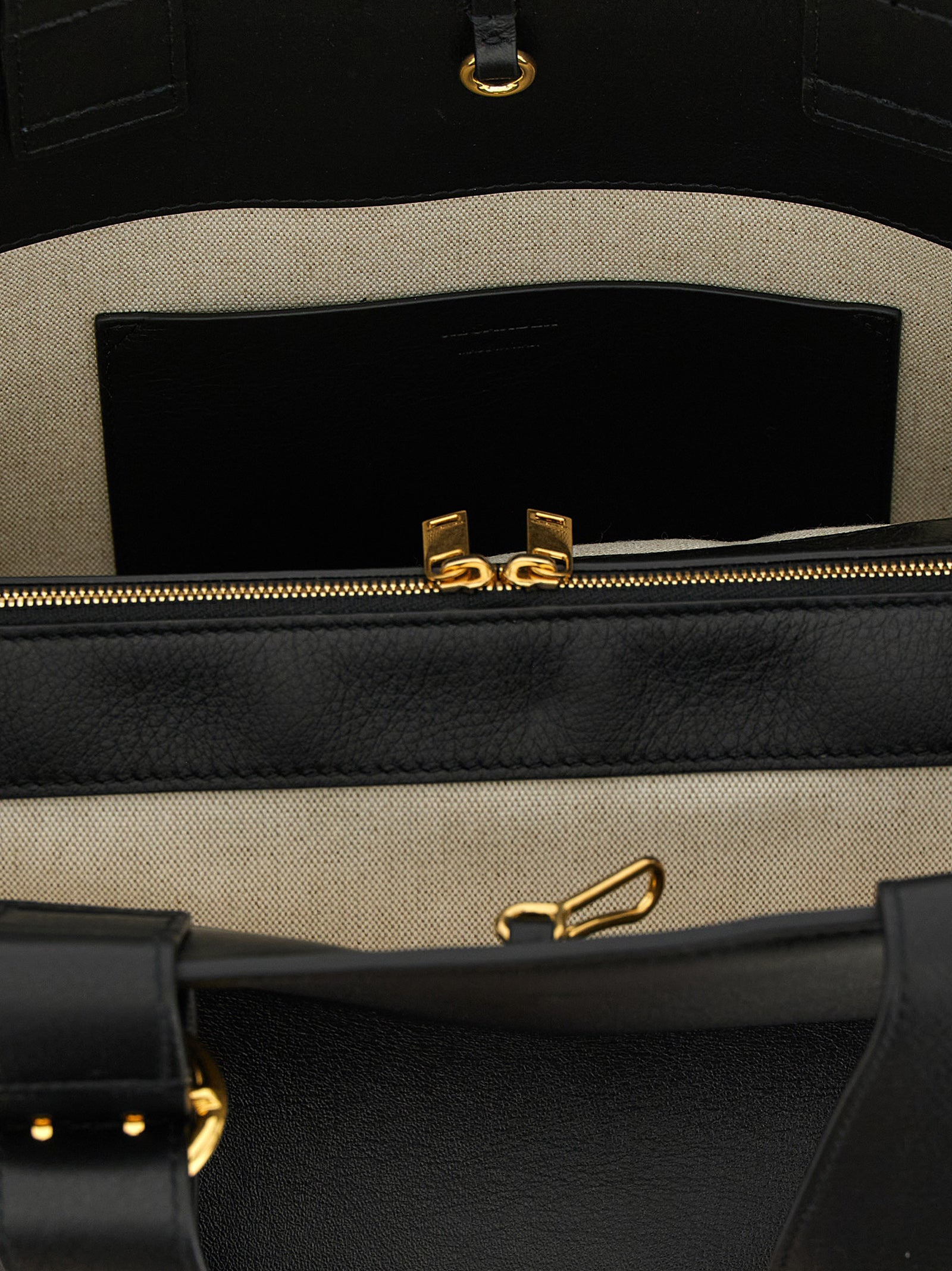 Experience the allure of the Jil Sander Black Calfskin Tote Bag, a masterpiece of artisanal luxury, crafted from premium calfskin for the discerning individual.
