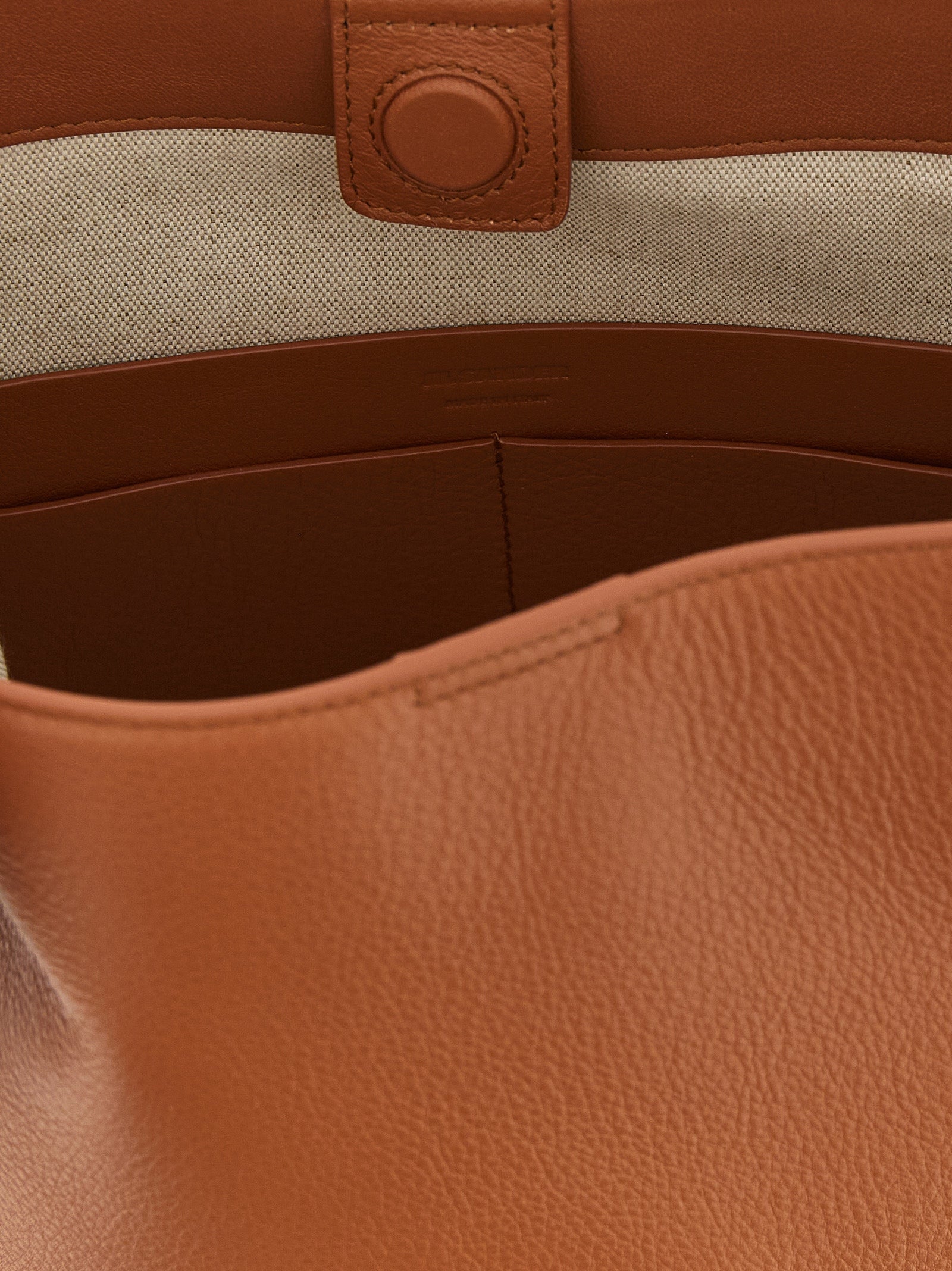 Discover the Jil Sander Brown Calfskin Shoulder Bag, a masterpiece of Italian craftsmanship in luxurious calfskin, designed for those who embody elegance and sophistication.