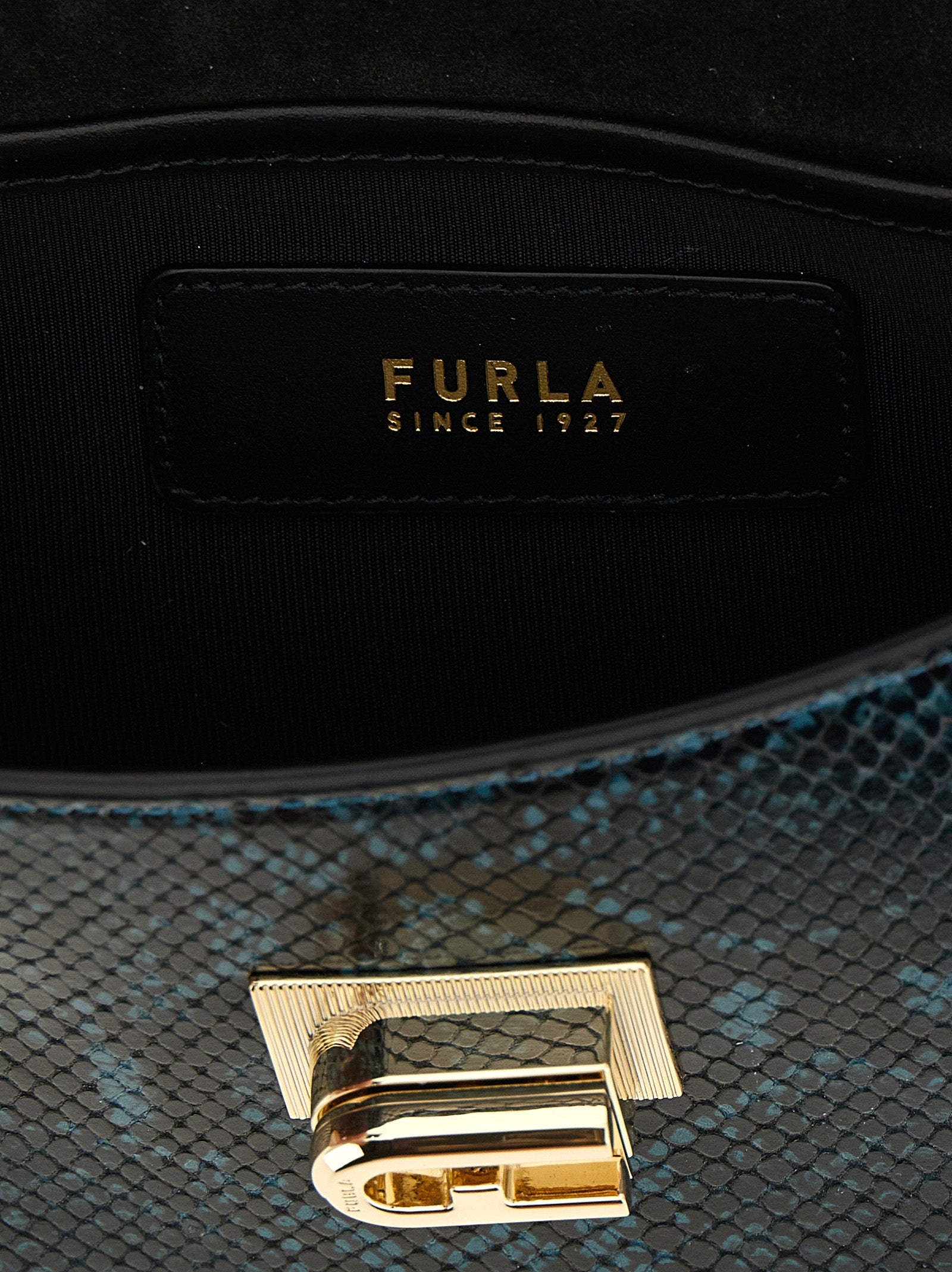 Discover the Furla Blue Goatskin Crossbody Bag, a masterpiece of artisanal craftsmanship, blending luxurious leather with timeless elegance for the discerning connoisseur.