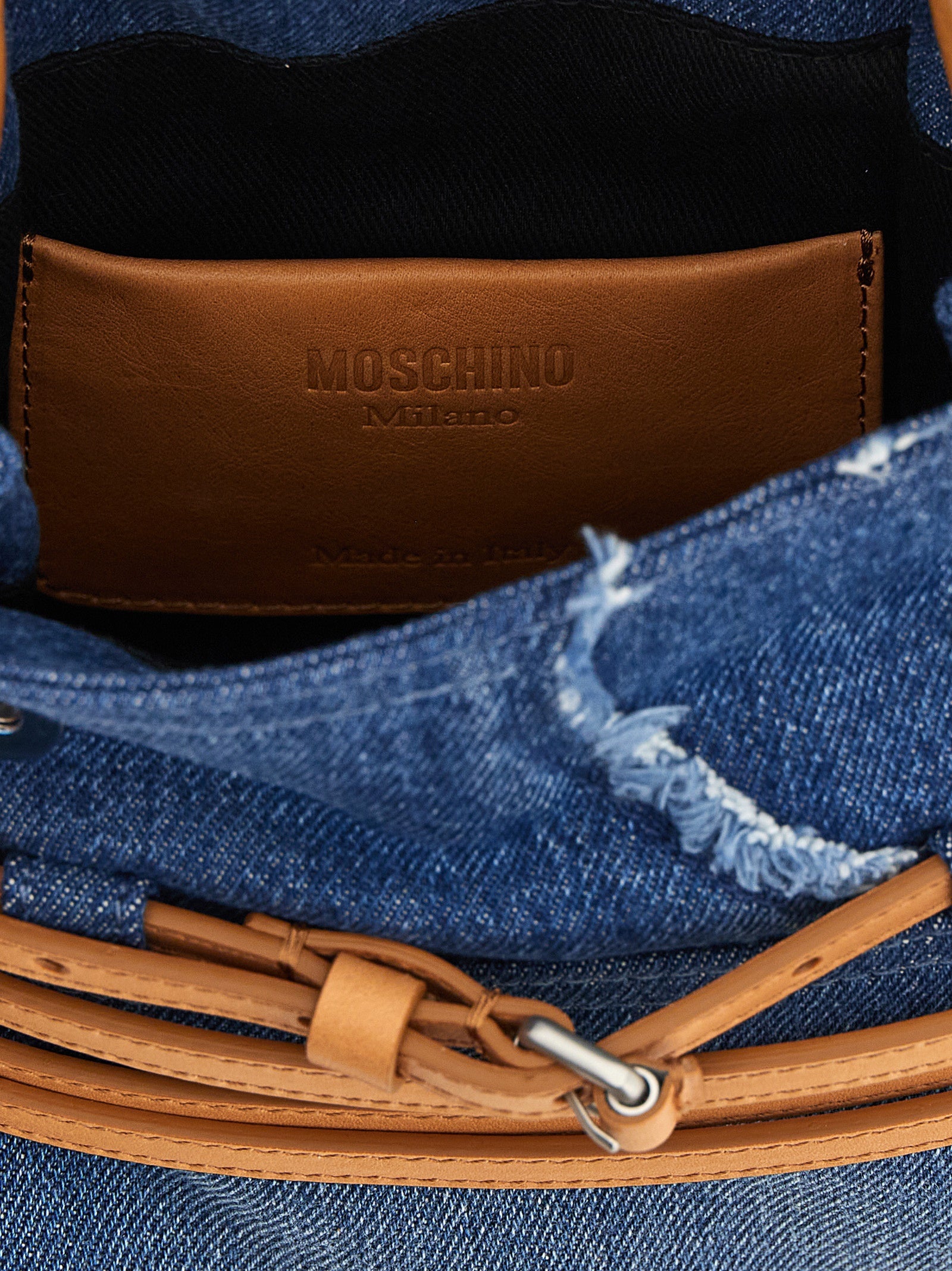 Indulge in the Moschino Blue Cotton Handbag, a luxurious blend of denim and leather, handcrafted in Italy to elevate your style with bold sophistication and timeless elegance.