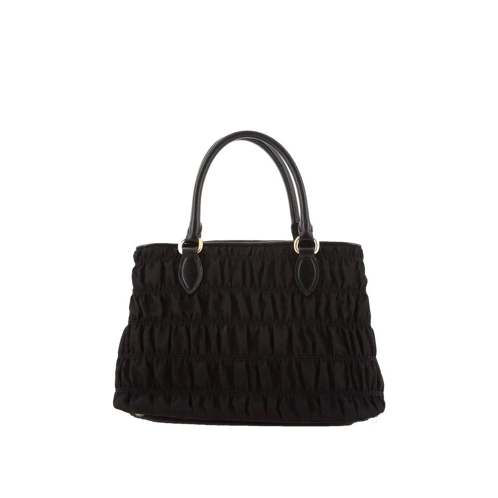Discover the Prada Black Nylon Handbag, a masterpiece of Italian craftsmanship, blending luxurious nylon and leather for the discerning individual who embodies elegance and sophistication.