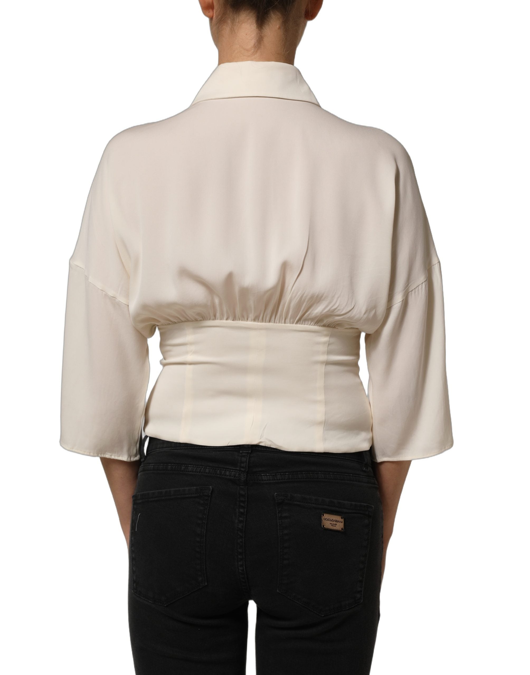 Experience the exquisite allure of the Dolce & Gabbana Off White Ascot Collar Blouse, crafted from a luxurious silk blend, embodying timeless elegance and Italian craftsmanship.