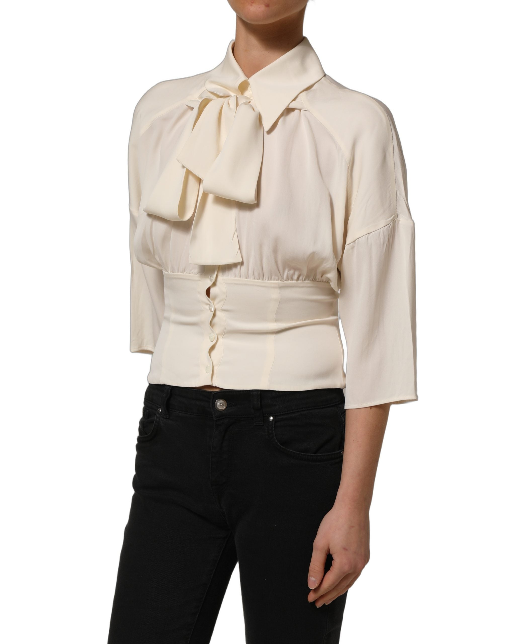 Elevate your wardrobe with the Dolce & Gabbana Off White Ascot Collar Blouse, a silk blend masterpiece that embodies timeless elegance and exquisite Italian craftsmanship.