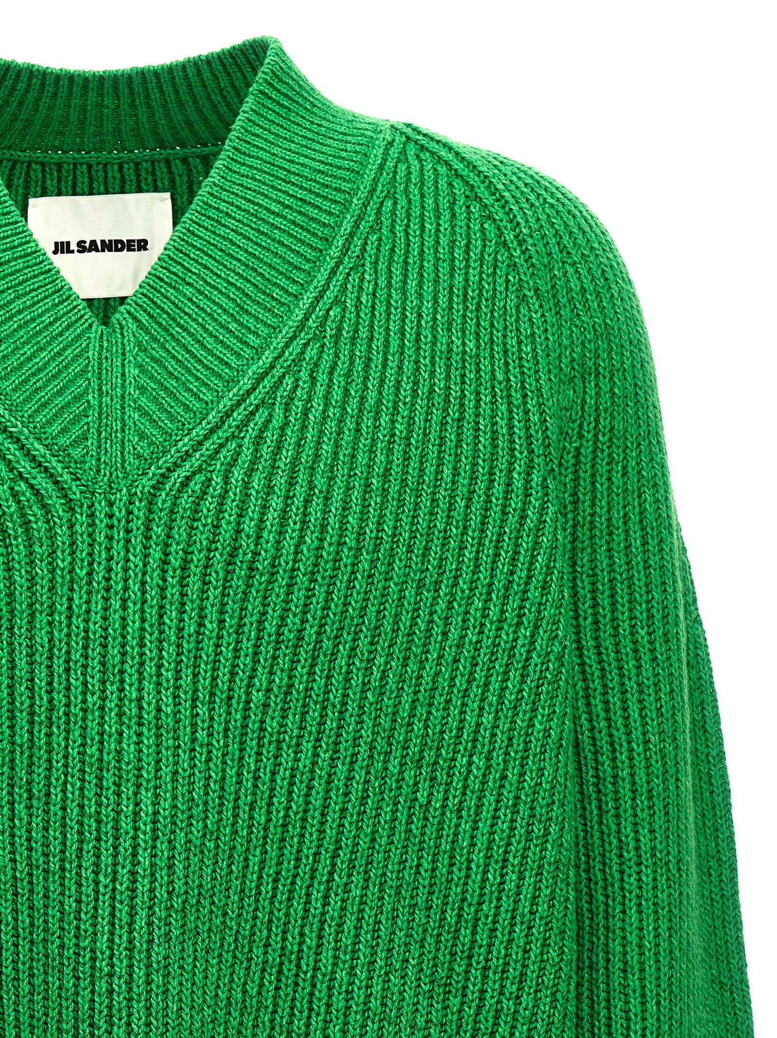 Indulge in the exquisite Jil Sander Bicolor Cotton Cardigan, a luxurious blend of cotton and wool, embodying timeless elegance and sophisticated style for the discerning individual.