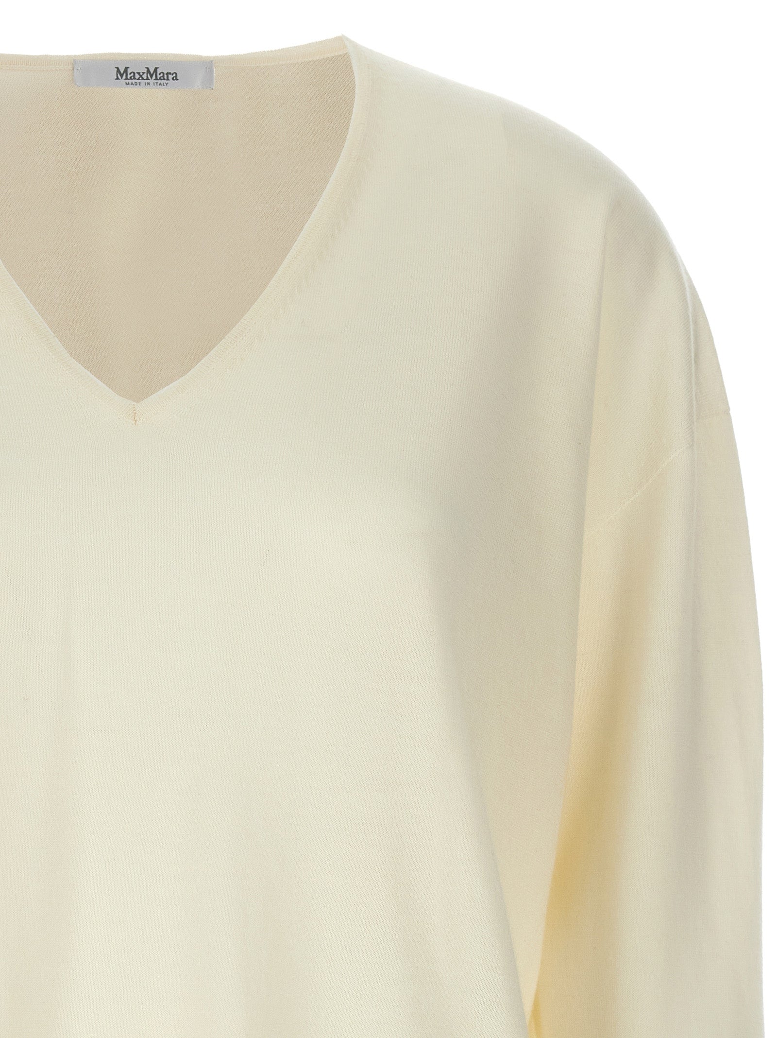 Experience the epitome of luxury with the Max Mara White Cashmere Cardigan, crafted from 100% cashmere, embodying timeless elegance for the discerning individual.
