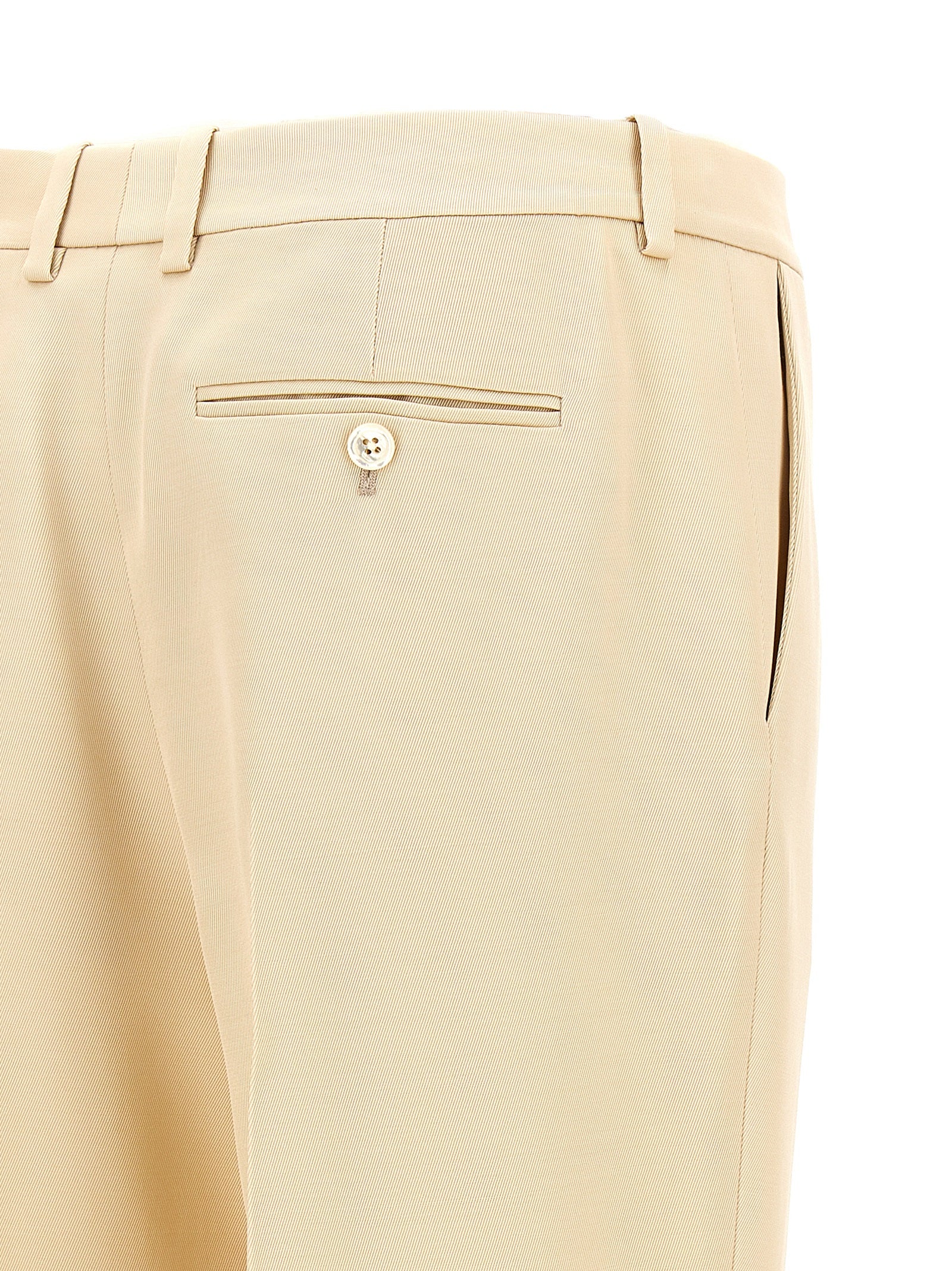 Elevate your elegance with Tom Ford's Beige Silk Dress Pants, a luxurious blend of silk and wool, embodying artisanal craftsmanship for the discerning individual.