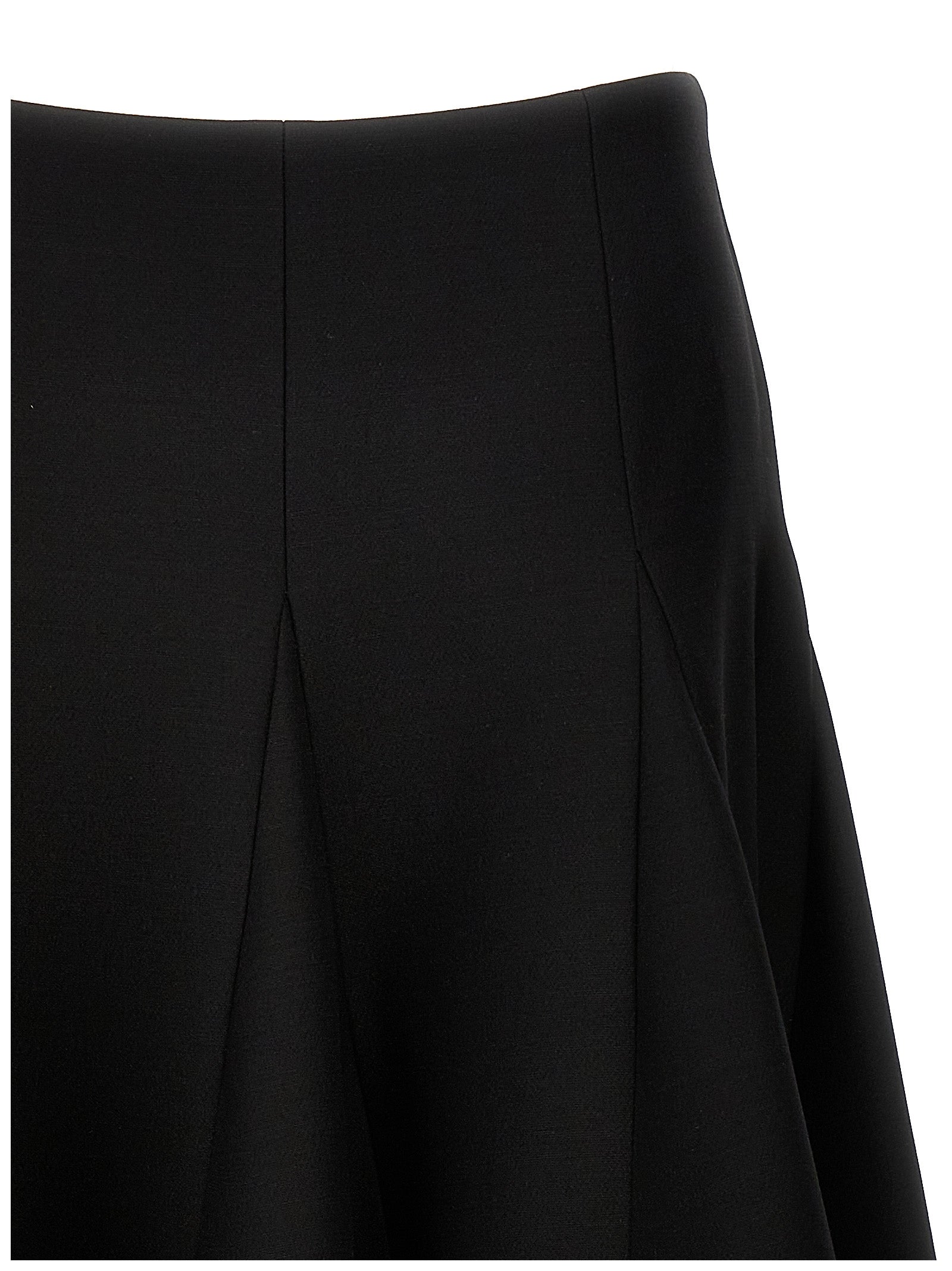 Elevate your wardrobe with the Valentino Garavani Black Virgin Wool Mini Skirt, a masterpiece of couture elegance crafted from luxurious virgin wool and silk for timeless sophistication.