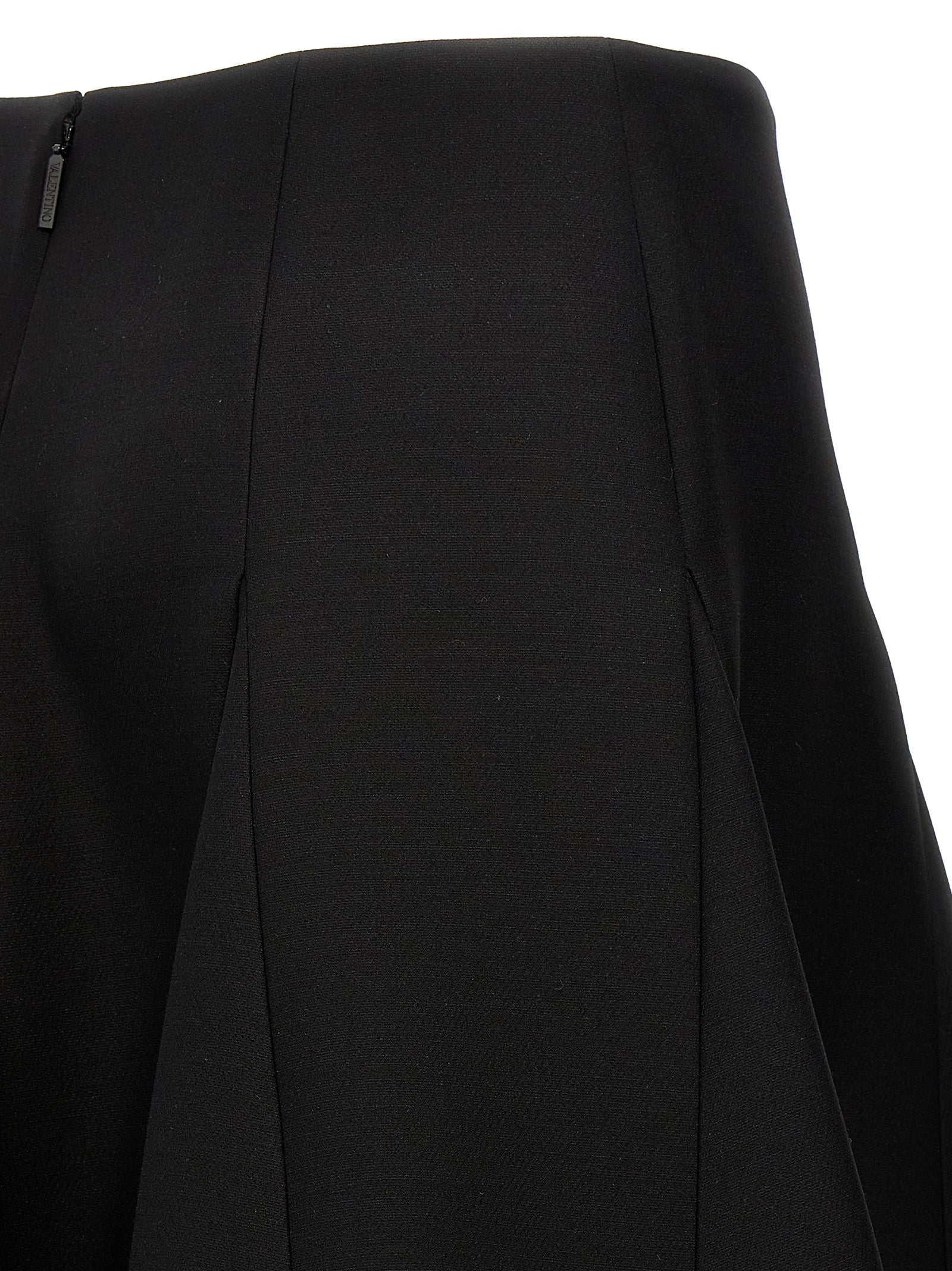 Elevate your wardrobe with the Valentino Garavani Black Virgin Wool Mini Skirt, a masterpiece of couture elegance crafted from luxurious virgin wool and silk.