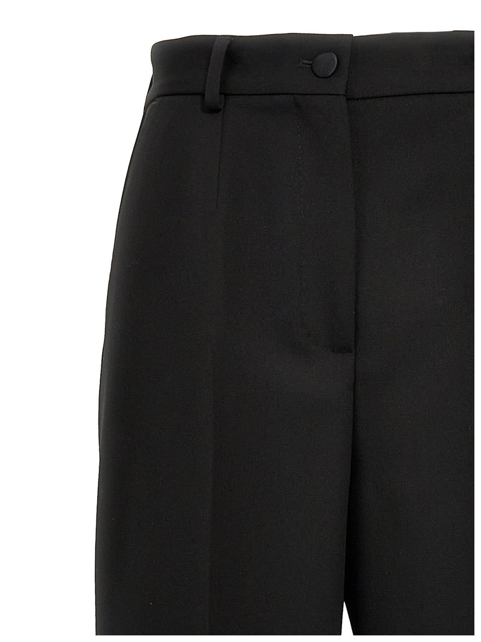 Elevate your elegance with the Dolce & Gabbana Black Virgin Wool Tuxedo, a masterpiece of Italian craftsmanship, blending luxurious materials for timeless sophistication.