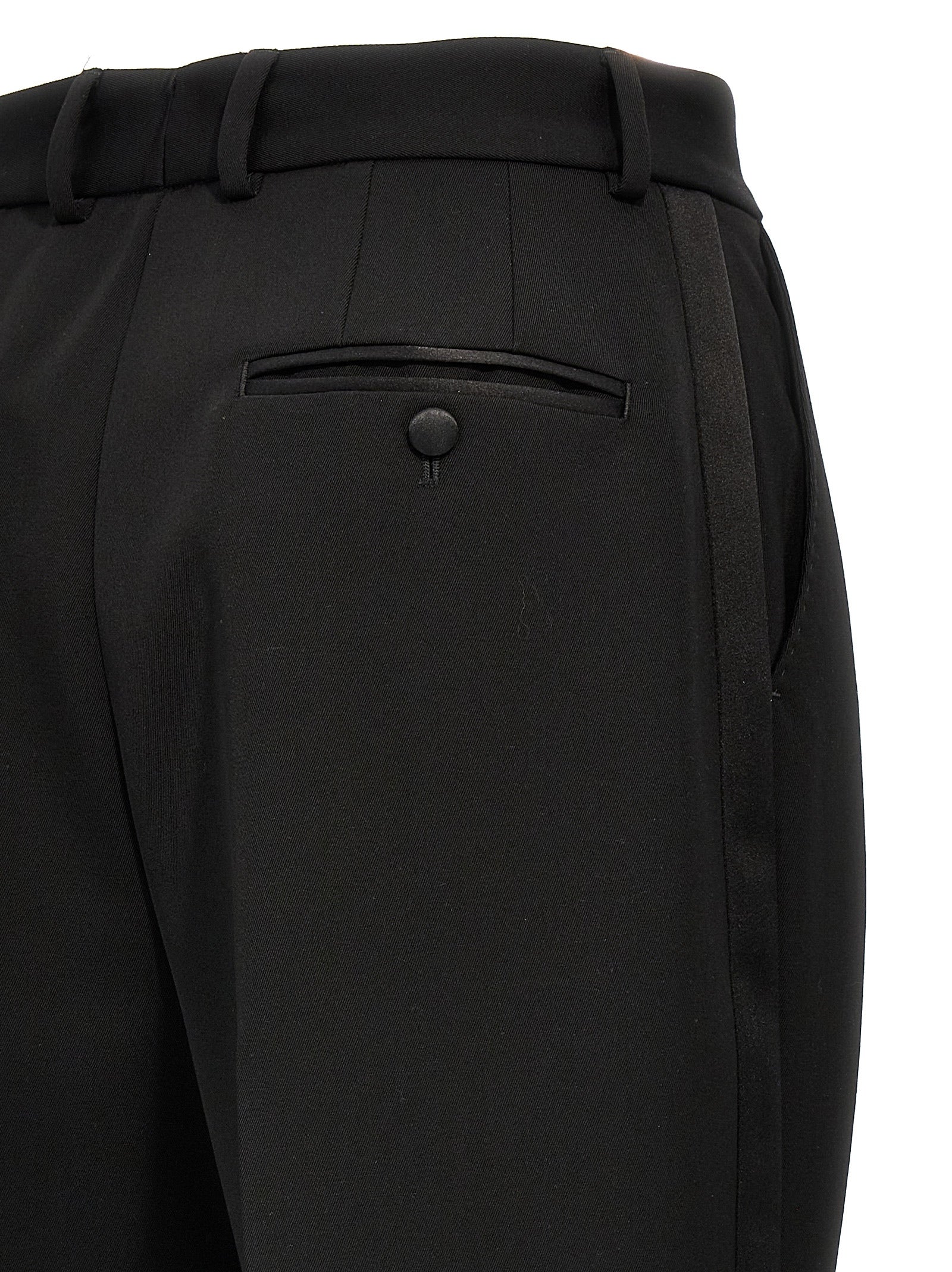 Elevate your wardrobe with the Dolce & Gabbana Black Virgin Wool Tuxedo, a masterpiece of Italian craftsmanship that embodies timeless elegance and sophistication.