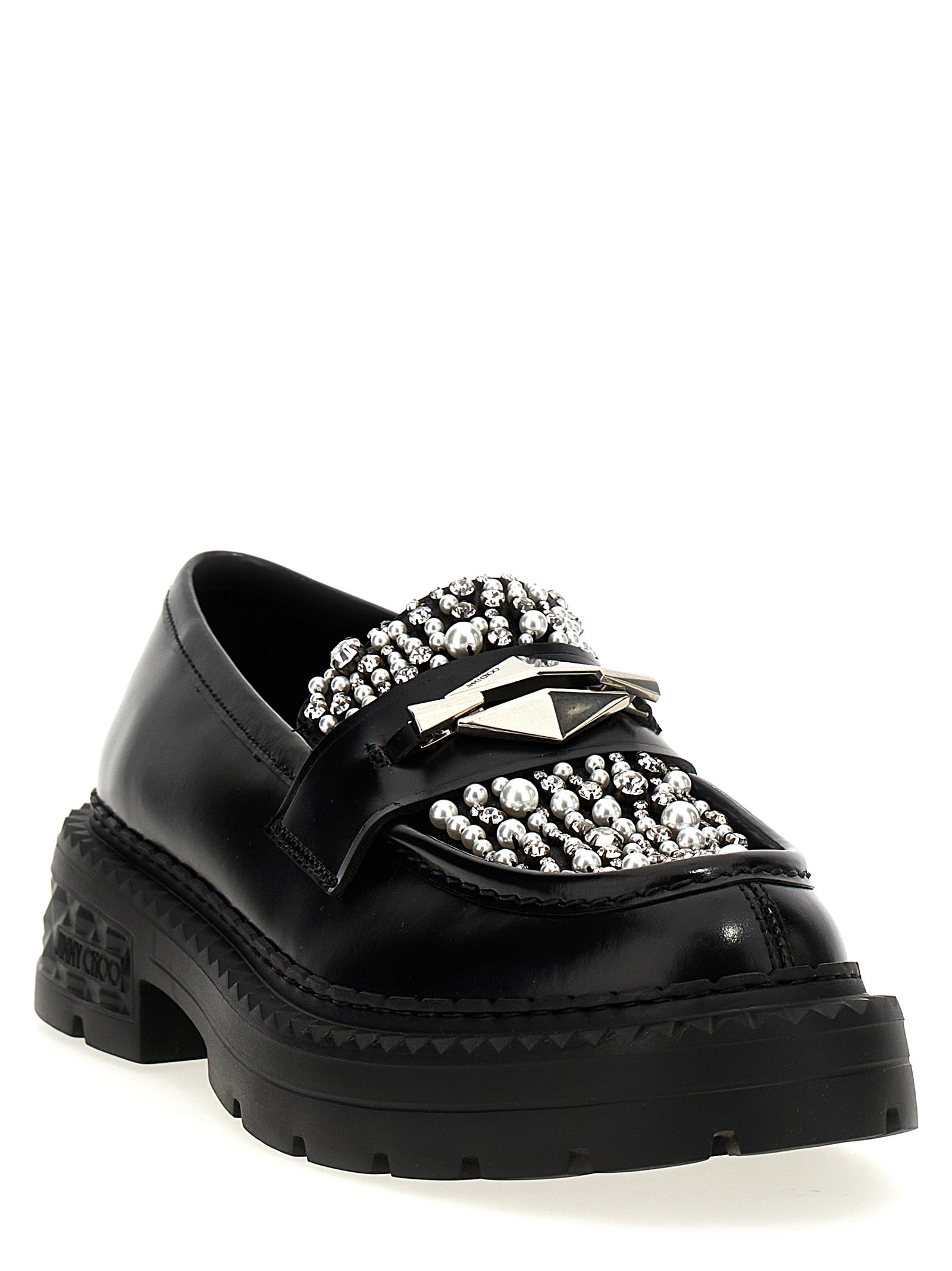 Elevate your style with Jimmy Choo's Black Calfskin Slip-On Loafers, where exquisite craftsmanship meets bold glamour, perfect for the discerning individual.