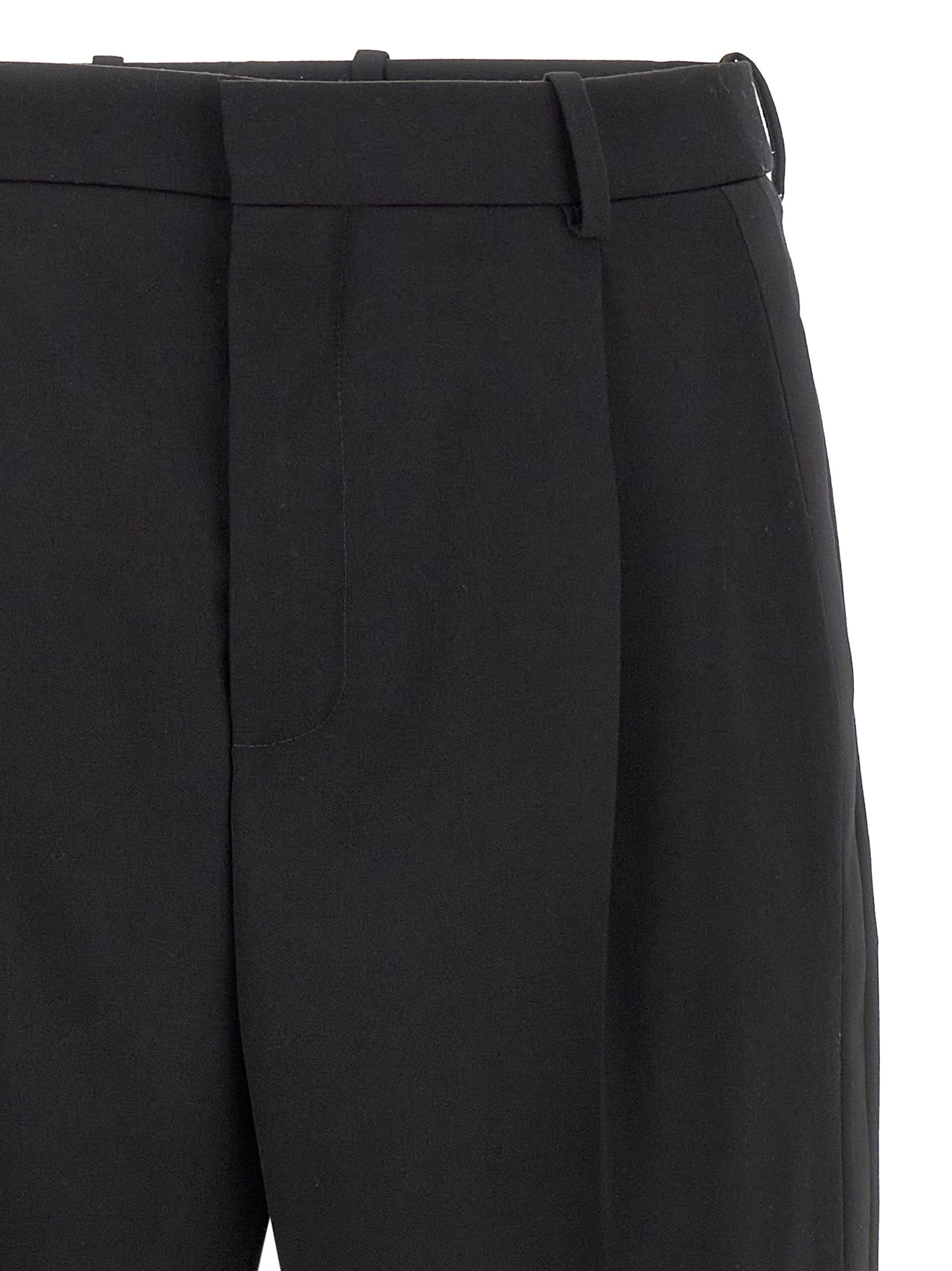 Elevate your wardrobe with Saint Laurent Black Wool Dress Pants, crafted from luxurious grain de poudre wool, embodying timeless sophistication for the discerning connoisseur.