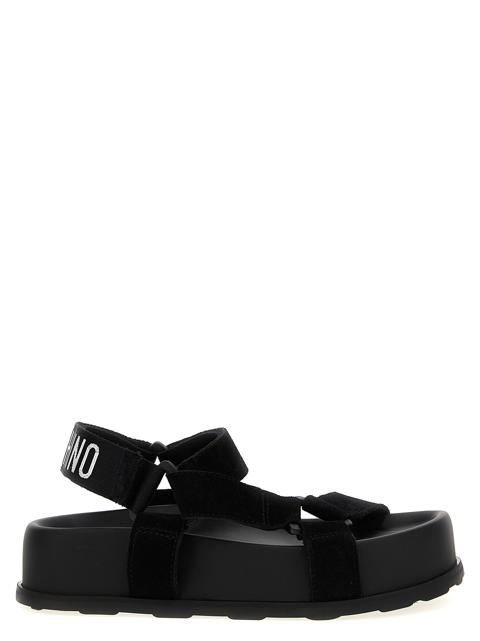 Step into a realm of opulence with Moschino Black Calfskin Flat Sandals, where exquisite craftsmanship meets bold design, perfect for the discerning connoisseur.