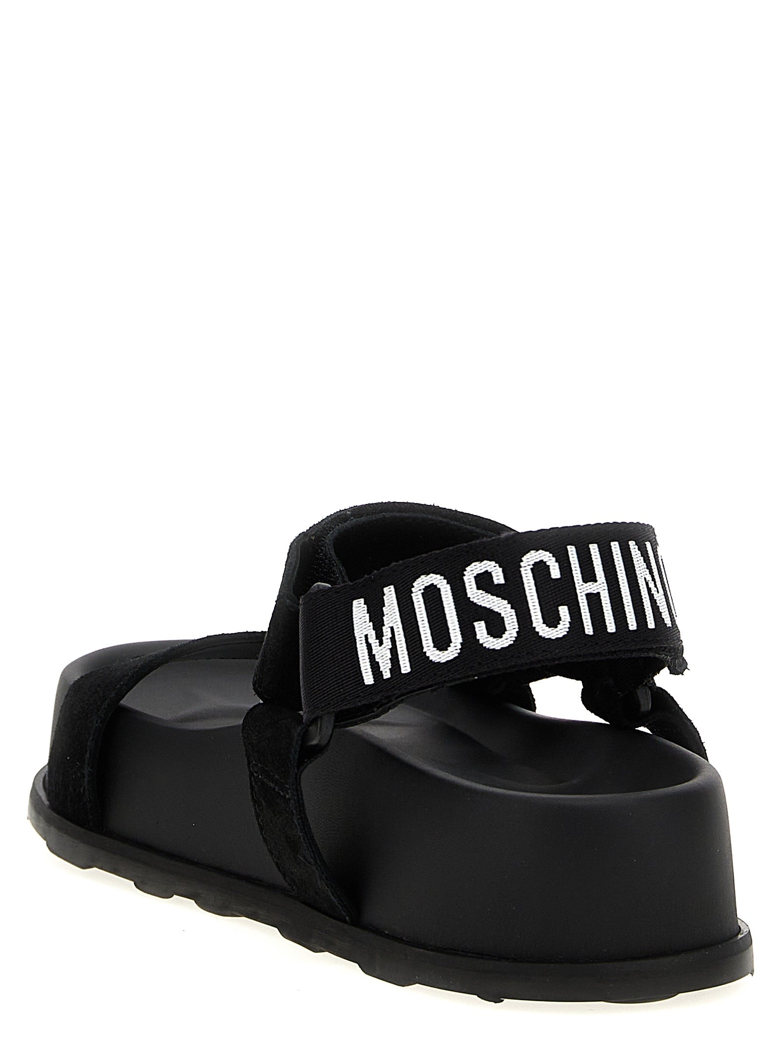Step into a realm of sophistication with Moschino Black Calfskin Flat Sandals, where artisanal craftsmanship meets bold design for the discerning connoisseur.