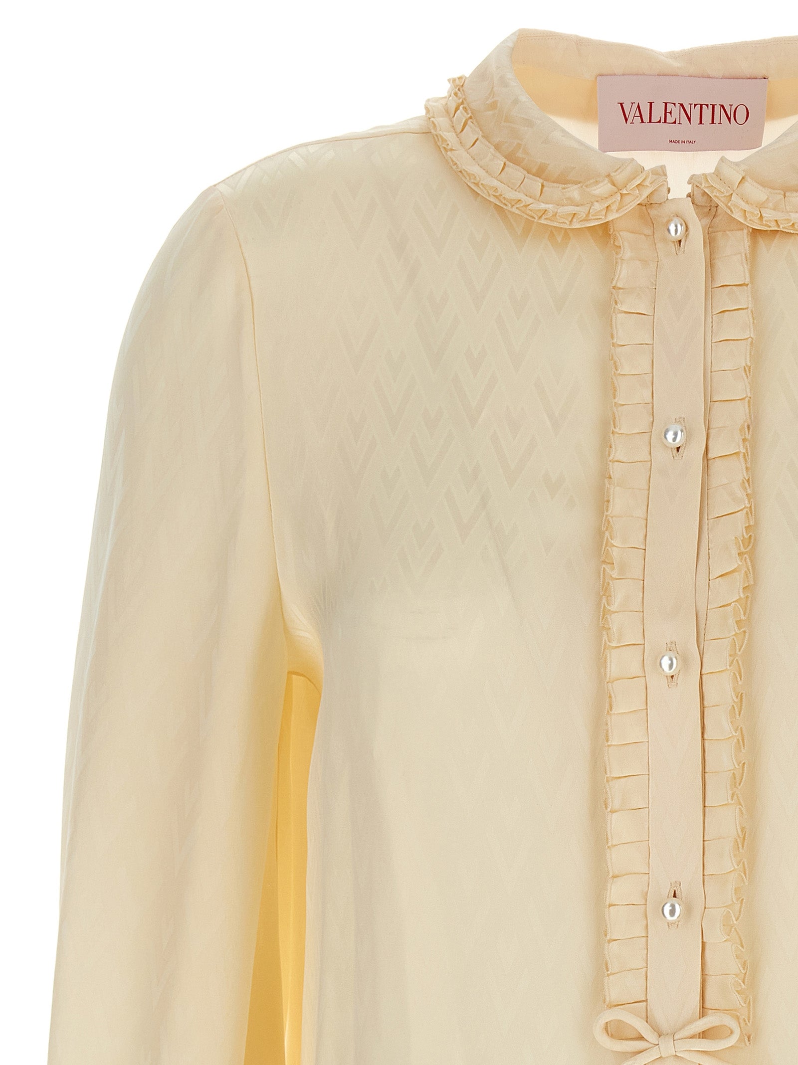 Experience the allure of the Valentino Garavani Beige Silk Blouse, a masterpiece of artisanal elegance crafted from luxurious silk, perfect for the discerning individual.