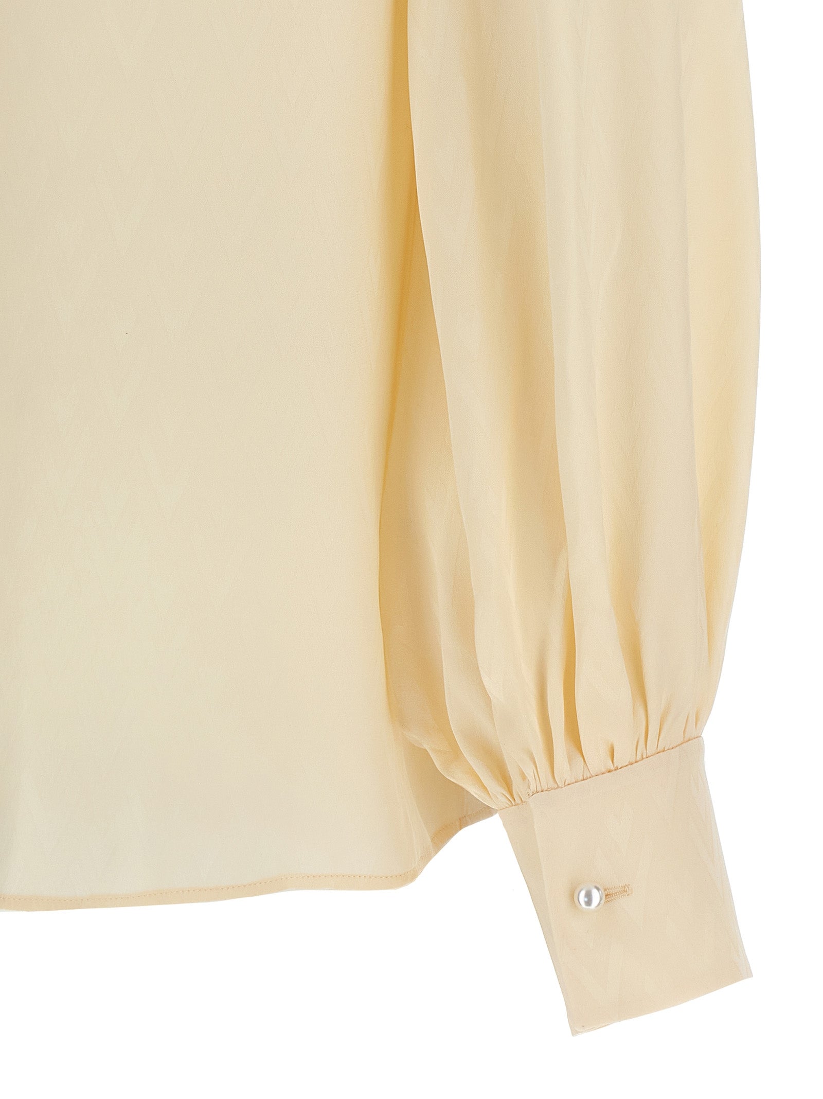 Elevate your wardrobe with the Valentino Garavani Beige Silk Blouse, a timeless piece crafted from luxurious silk, embodying artisanal elegance and sophistication.