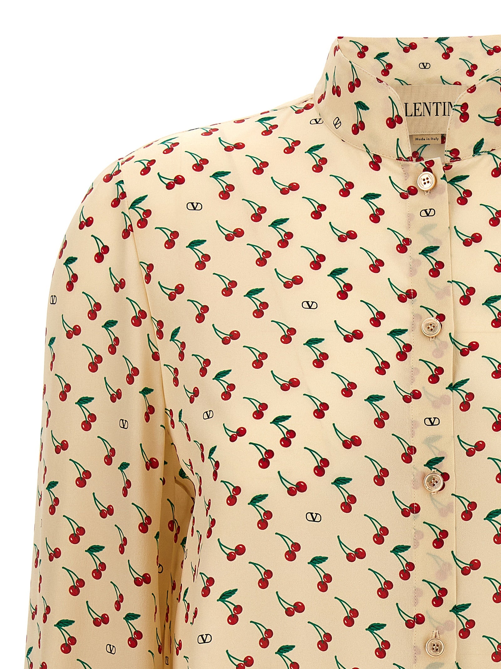 Discover the Valentino Garavani Beige Silk Blouse, a masterpiece of Italian craftsmanship featuring an audacious 'Cherryfic' print, perfect for elevating your sophisticated style.