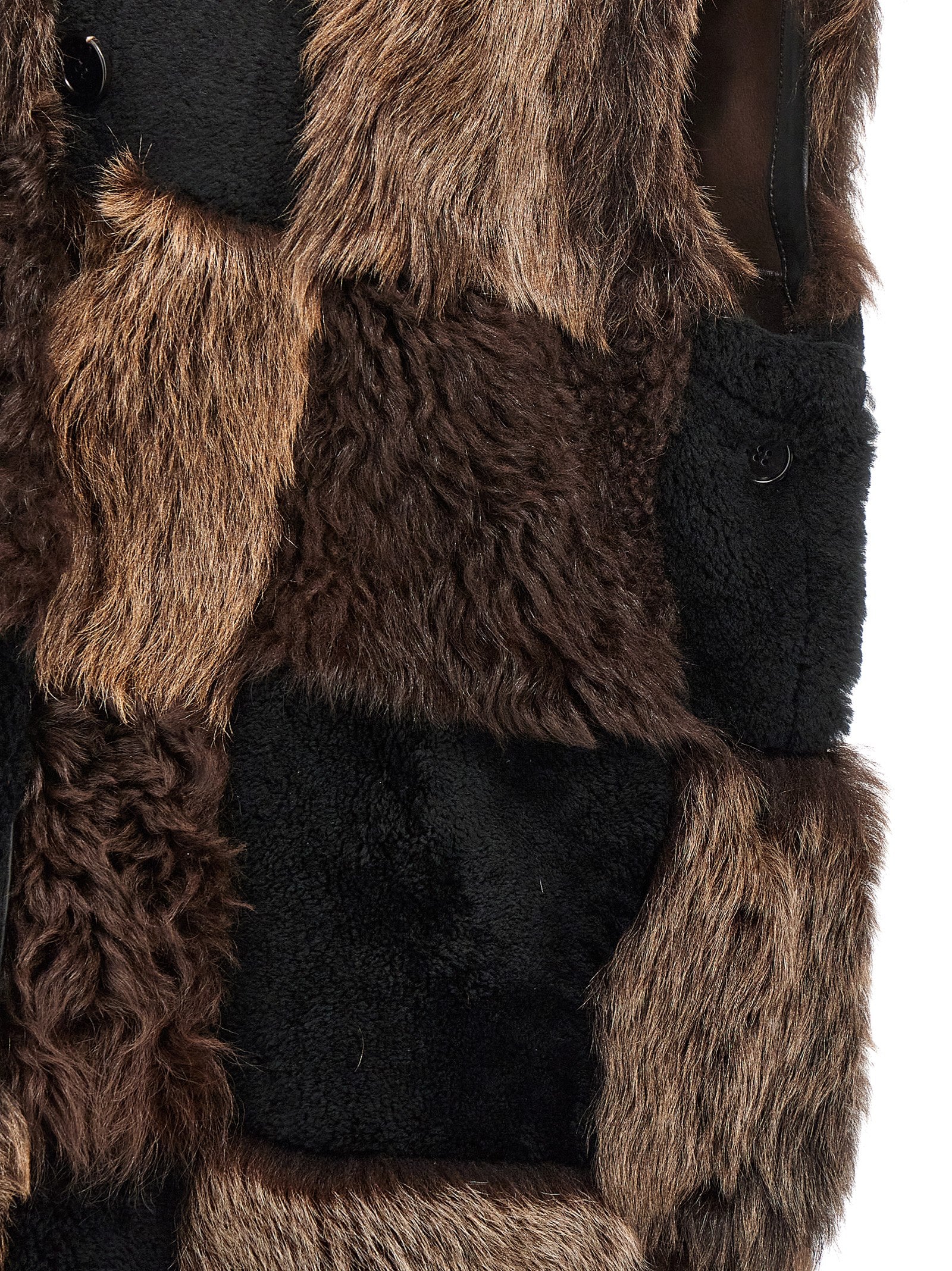 Indulge in the exquisite Marni Brown Lamb Fur Sleeveless Jacket, a masterpiece of Italian craftsmanship that elevates your style with luxurious lamb fur and a striking checkerboard design.
