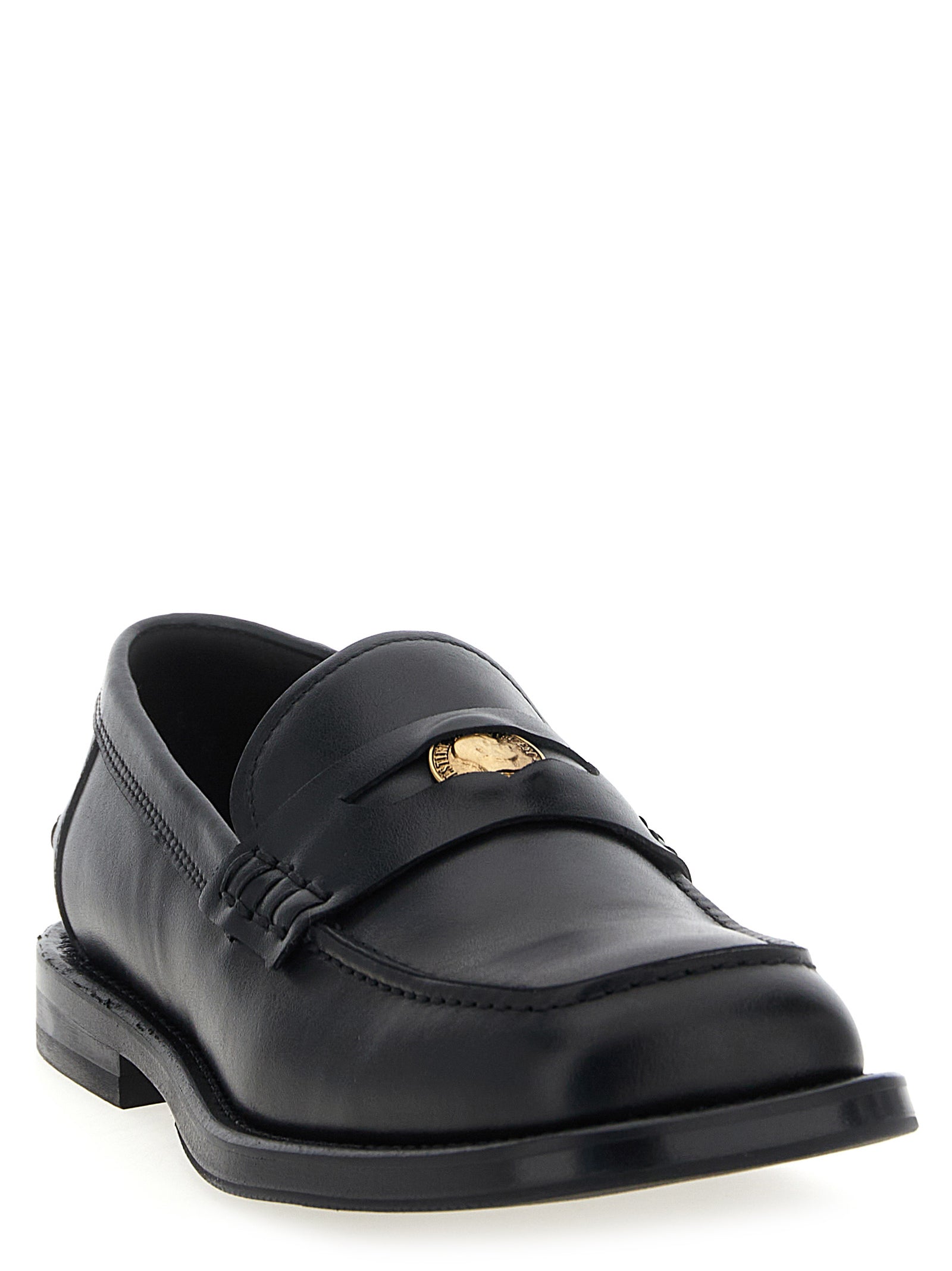 Indulge in the exquisite Moschino Black Velvet Leather Slip-On Loafers, where Italian craftsmanship meets bold elegance, perfect for the discerning individual.