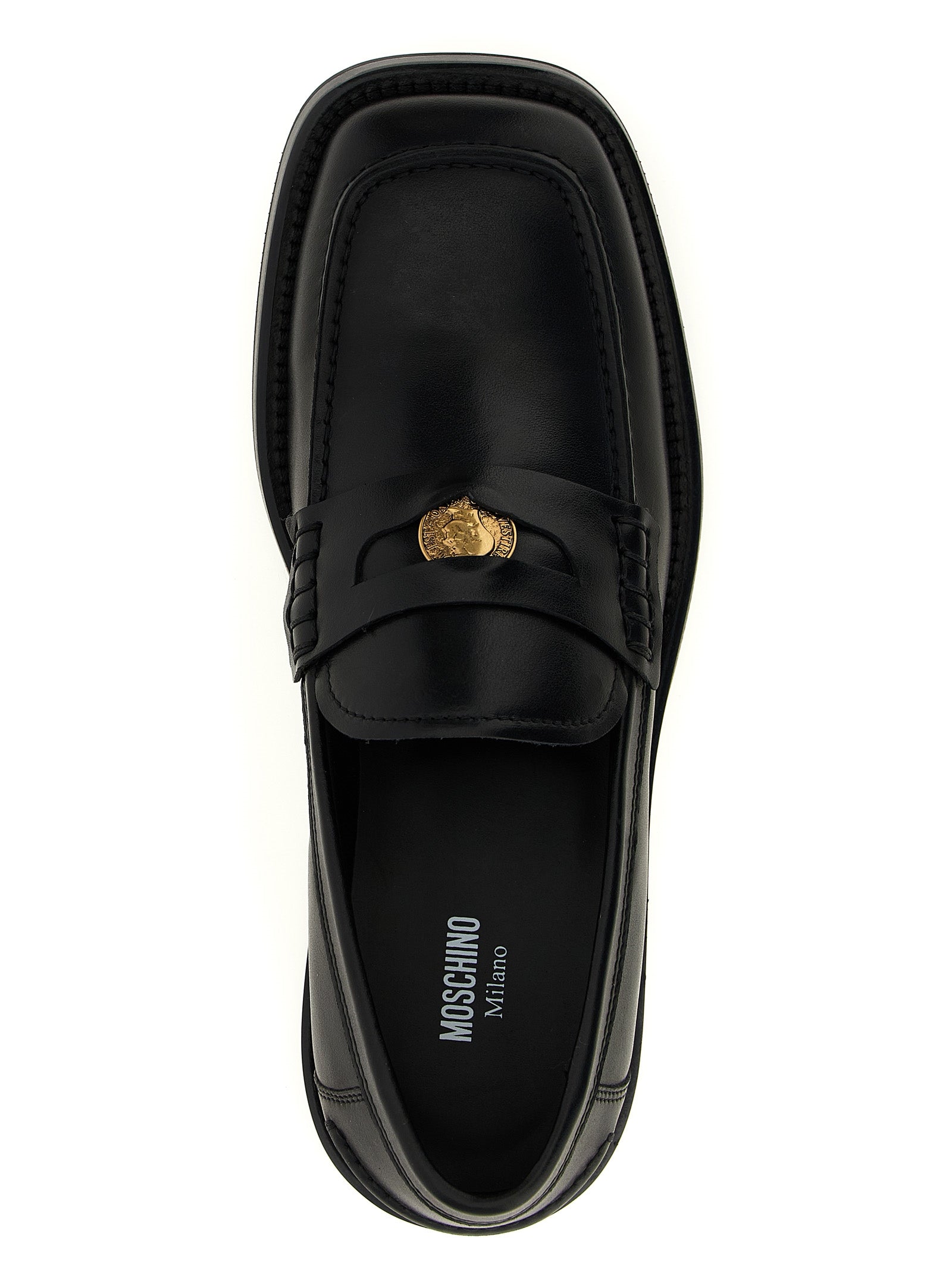 Experience the allure of Moschino's Black Velvet Leather Slip-On Loafers, where Italian craftsmanship meets bold design, embodying luxury and sophistication for the discerning individual.