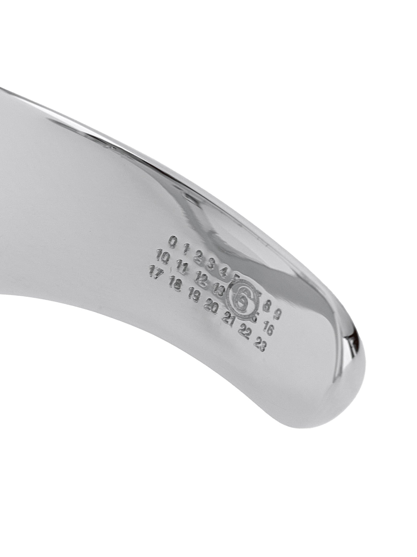 Experience the artisanal elegance of the MM6 Maison Margiela Silver Brass Bracelet, a timeless piece that elevates your style with luxurious sophistication.