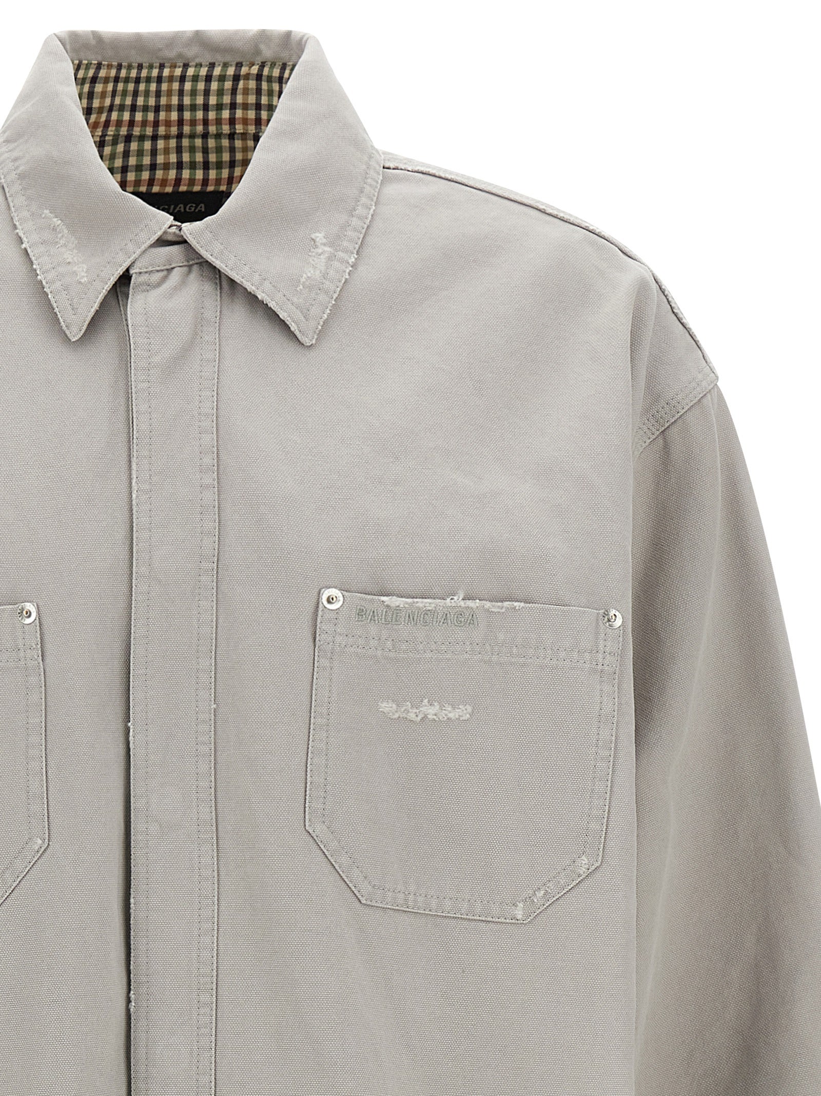 Elevate your style with the Balenciaga Gray Cotton Blouse, a luxurious blend of rugged charm and refined elegance, perfect for the discerning fashion connoisseur.
