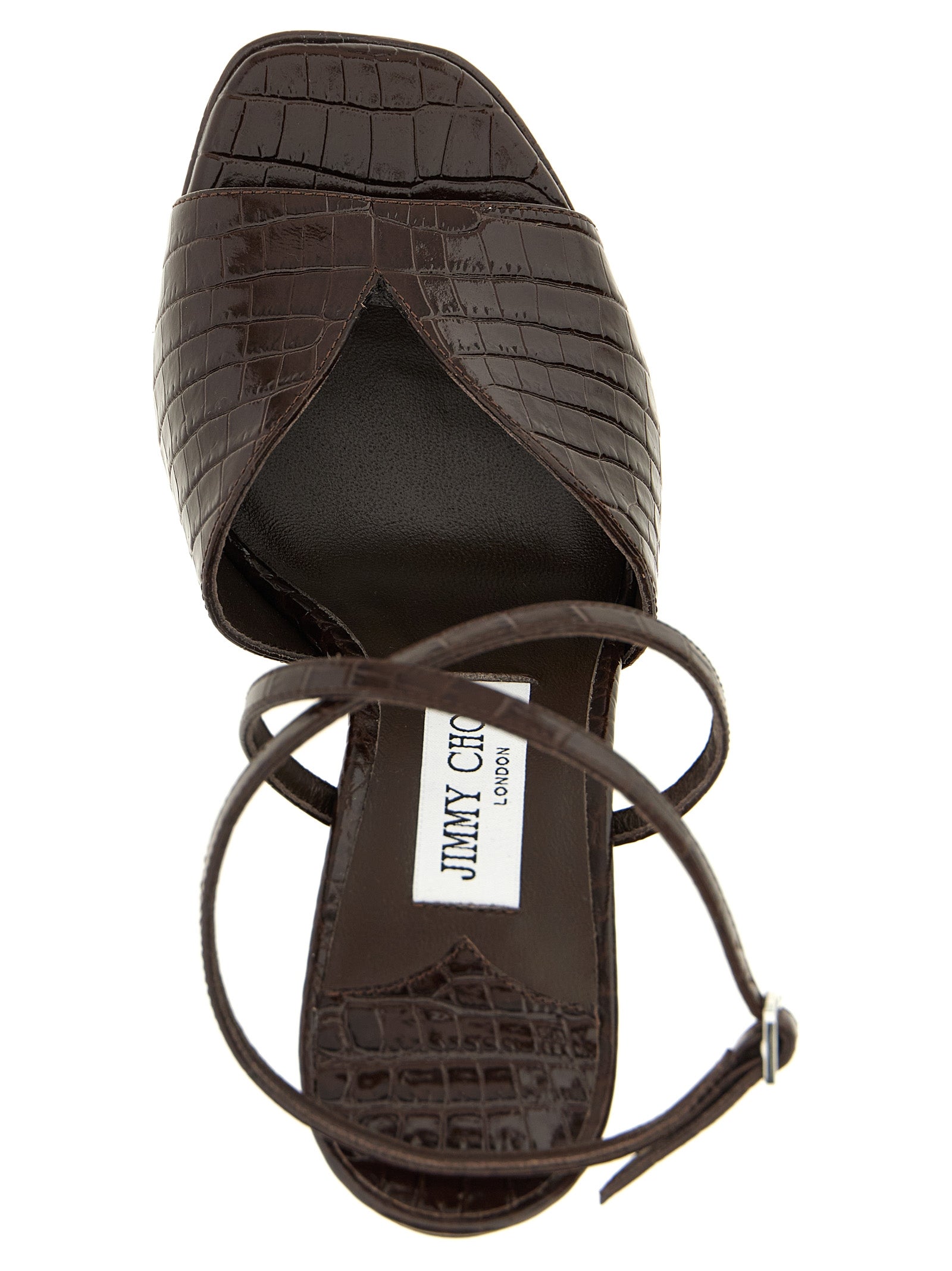 Experience the allure of Jimmy Choo's Karli Brown Leather Stiletto Heel Sandals, where exquisite crocodile-print leather meets unparalleled craftsmanship for a statement of luxury.
