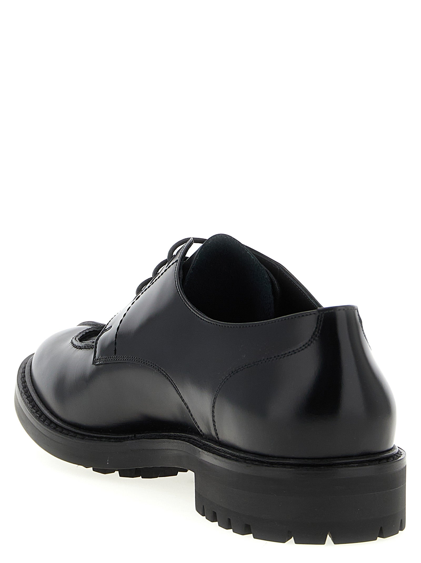 Experience the exquisite craftsmanship of Saint Laurent's Black Calfskin Oxfords, where timeless luxury meets modern elegance for the discerning connoisseur.