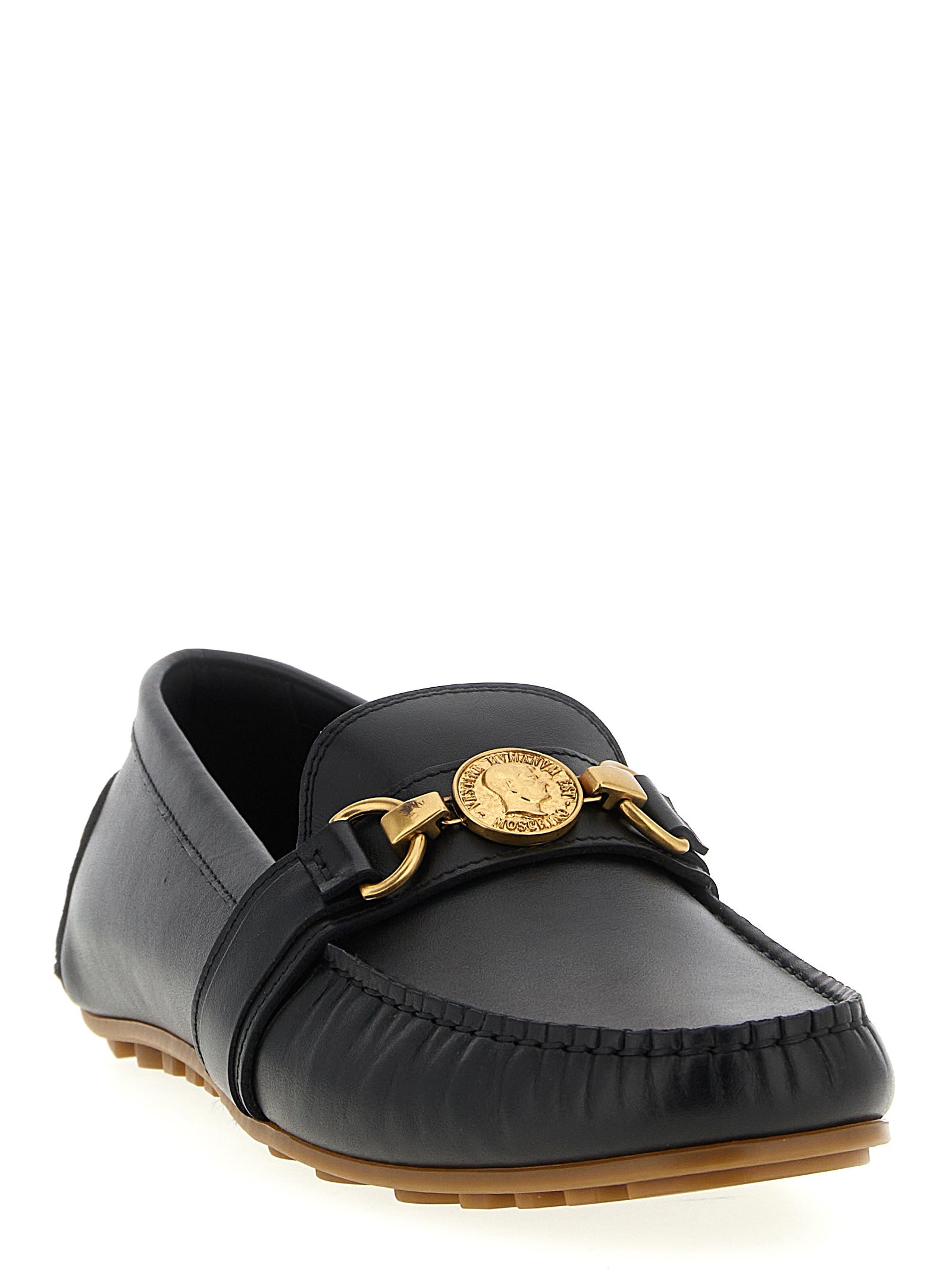 Indulge in the exquisite craftsmanship of Moschino Black Leather Slip-On Loafers, where timeless elegance meets modern sophistication for the discerning individual.
