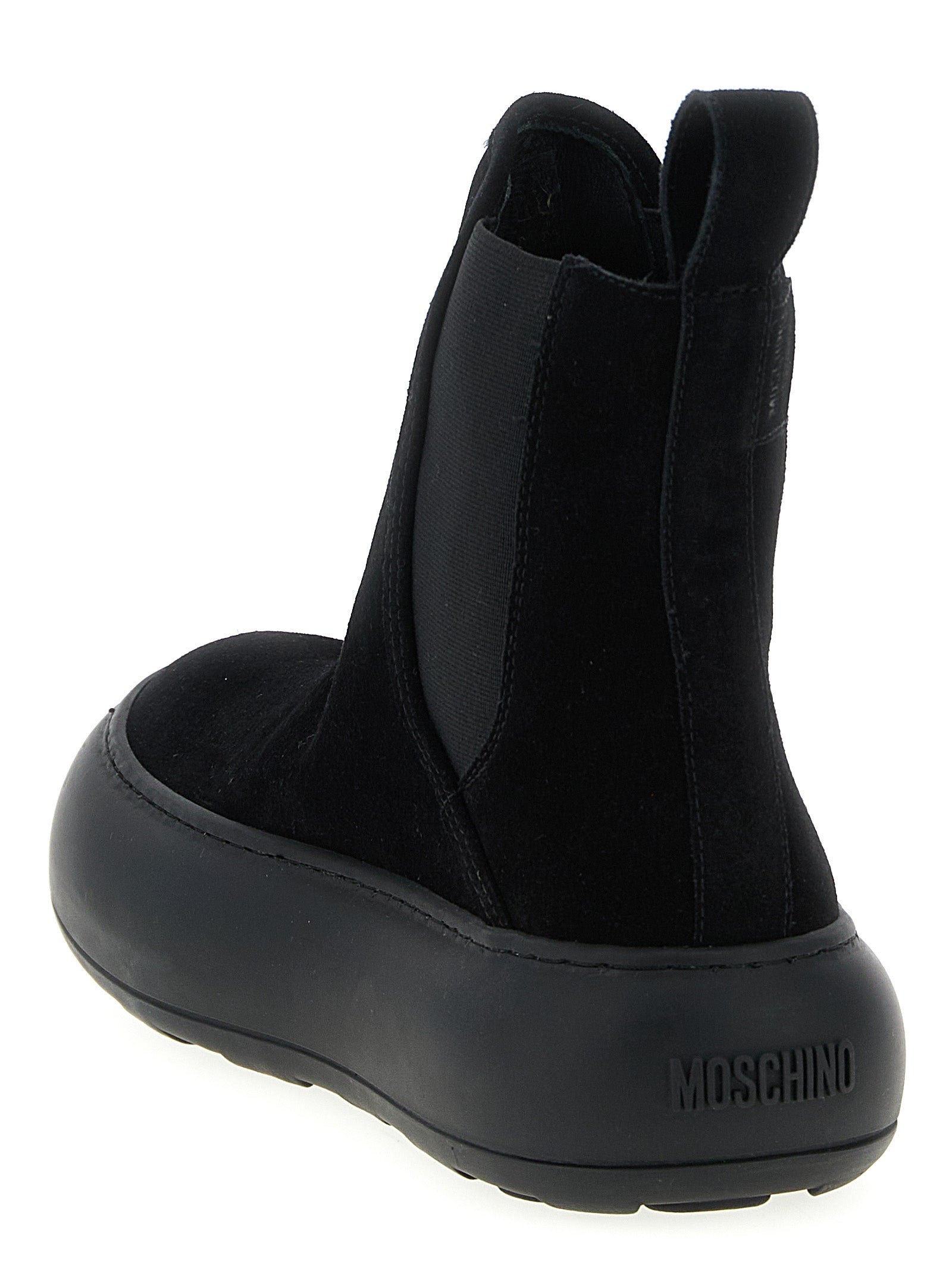 Experience the artistry of Moschino Black Calfskin Chelsea Boots, where exquisite craftsmanship meets timeless elegance, elevating your style to new heights.