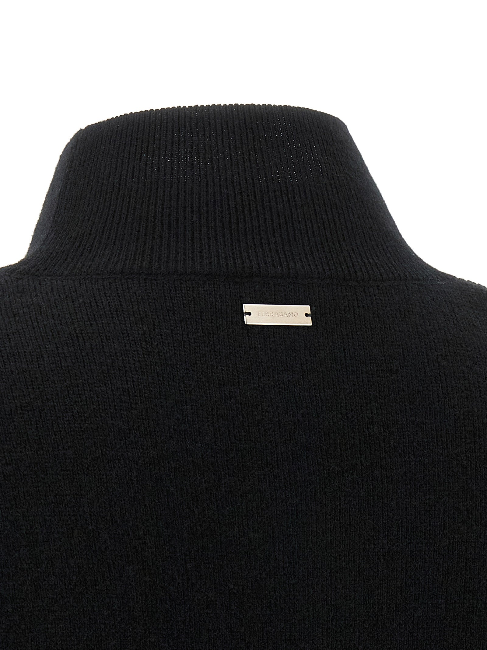 Indulge in the Ferragamo Black Virgin Wool Cardigan, a masterpiece of luxury and elegance, crafted from sumptuous virgin wool and cashmere for the discerning connoisseur.