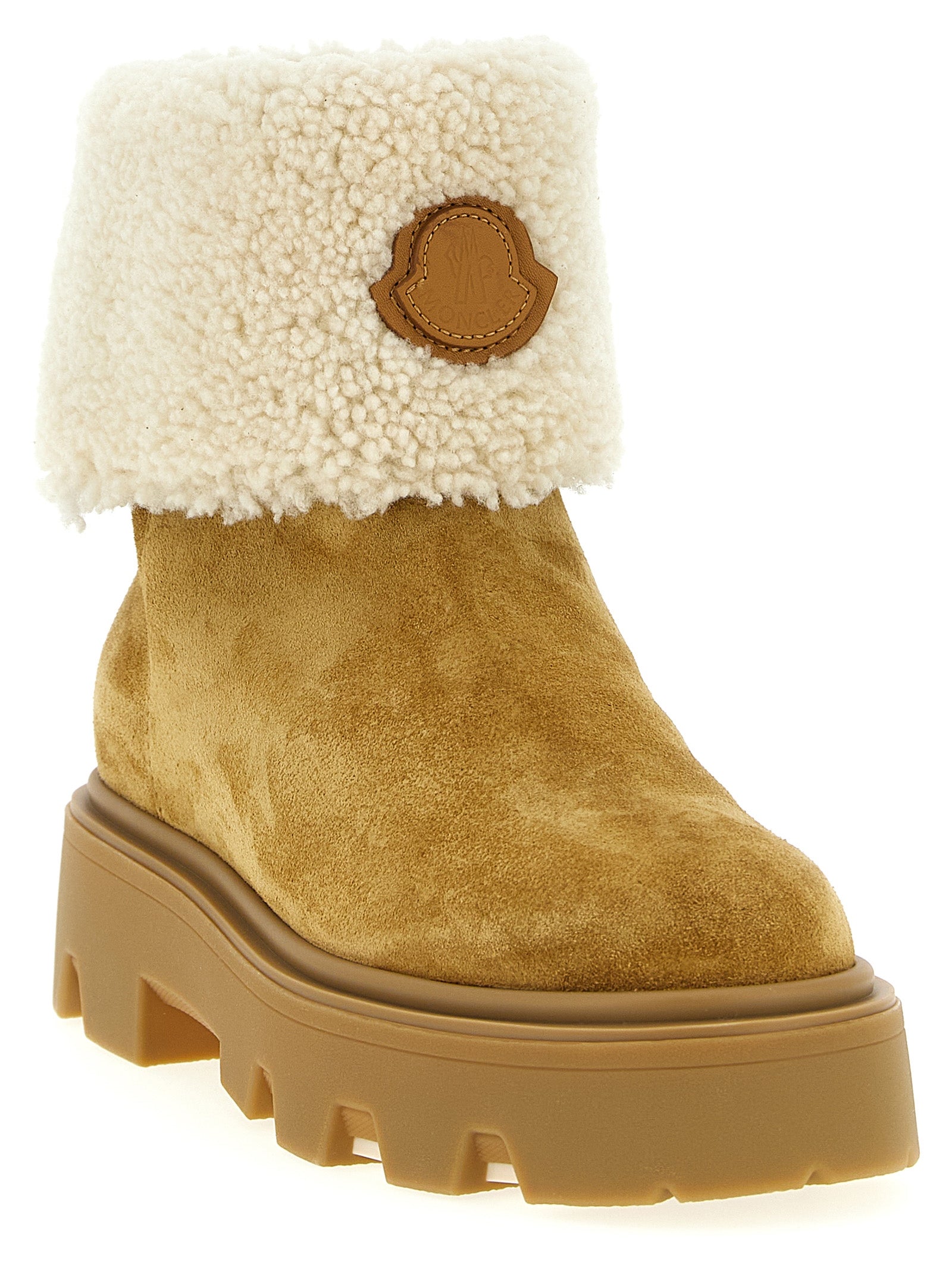 Indulge in Moncler's Aurea beige calfskin ankle boots, where luxurious shearling meets timeless craftsmanship, elevating your style to new heights of sophistication.