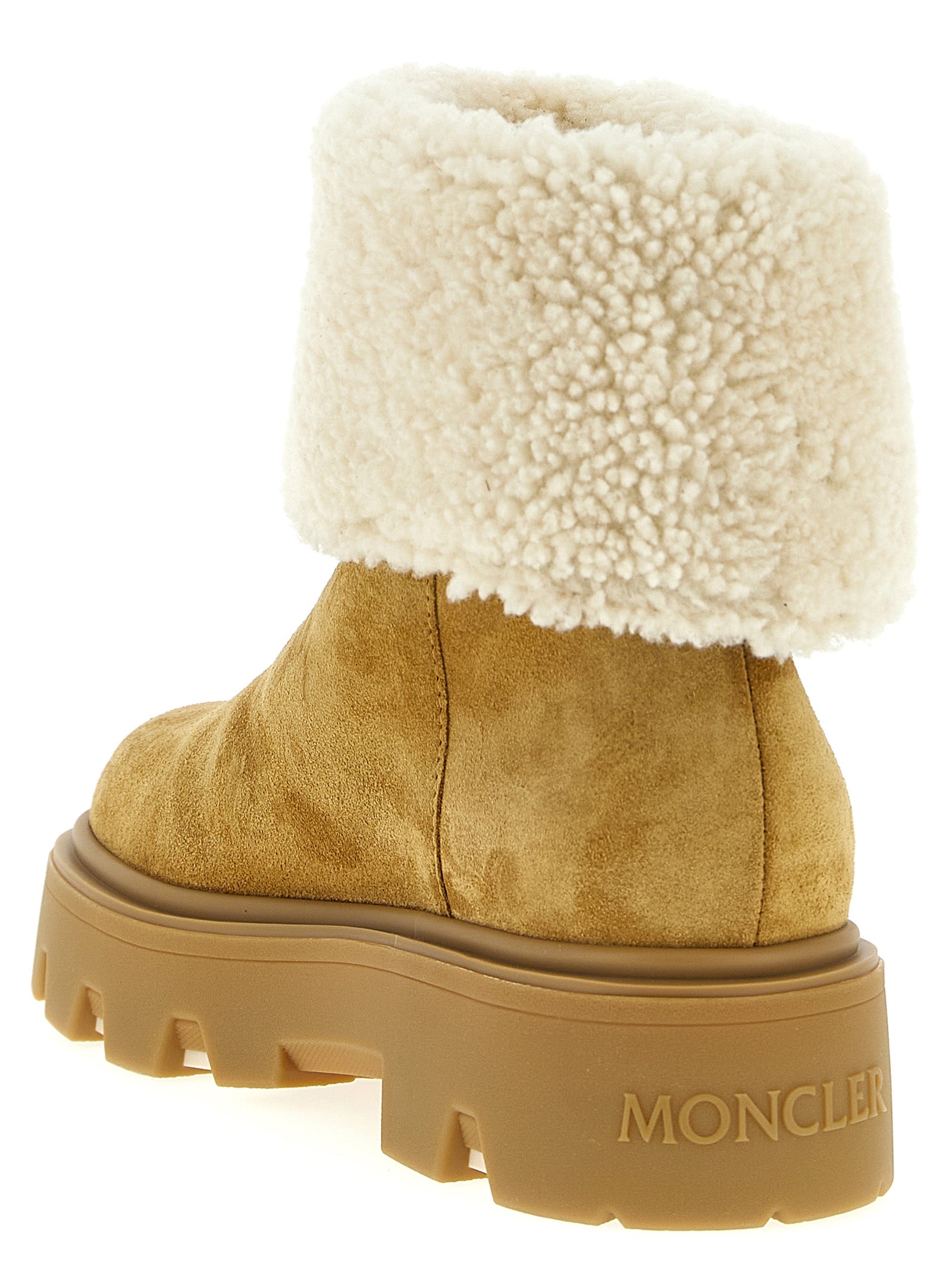 Indulge in Moncler's Aurea beige calfskin ankle boots, where luxurious shearling meets timeless craftsmanship, elevating your style with every step.