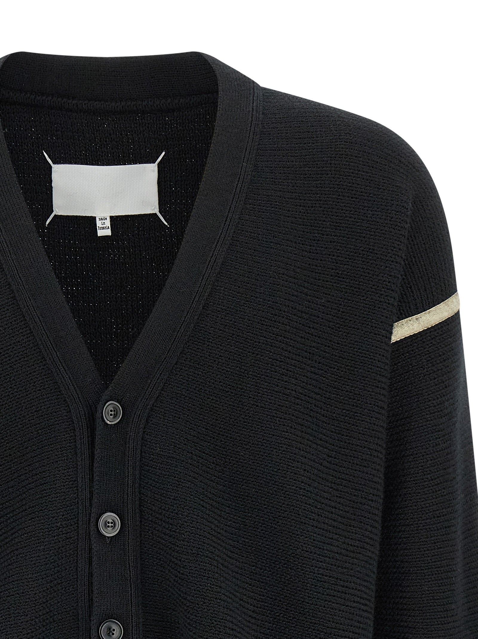Indulge in the Maison Margiela Black Virgin Wool Cardigan, a luxurious blend of craftsmanship and sophistication, perfect for those who embrace elegance and individuality.