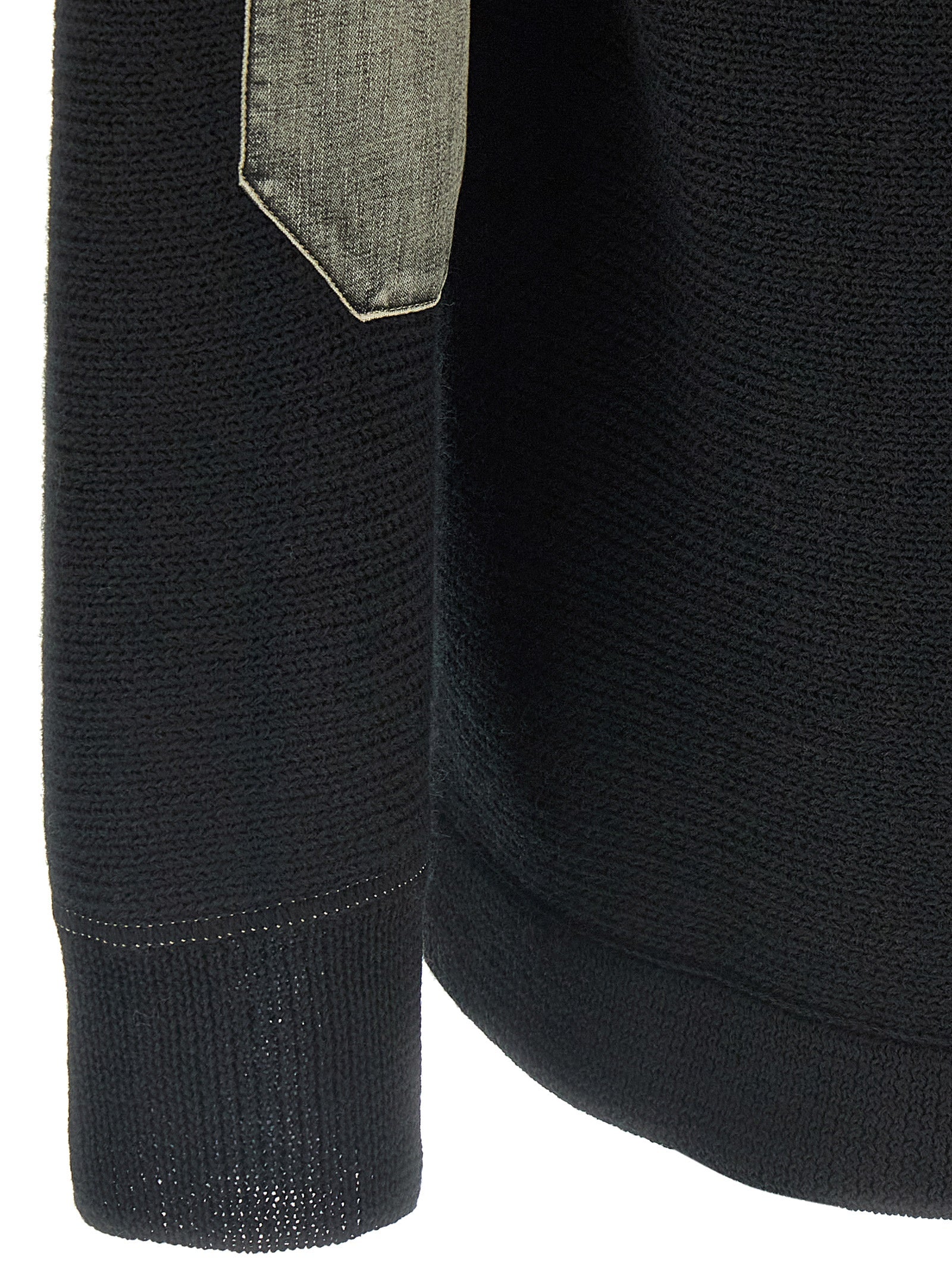 Indulge in the Maison Margiela Black Virgin Wool Cardigan, a masterpiece of artisanal luxury crafted from 100% virgin wool, embodying sophistication and effortless elegance.