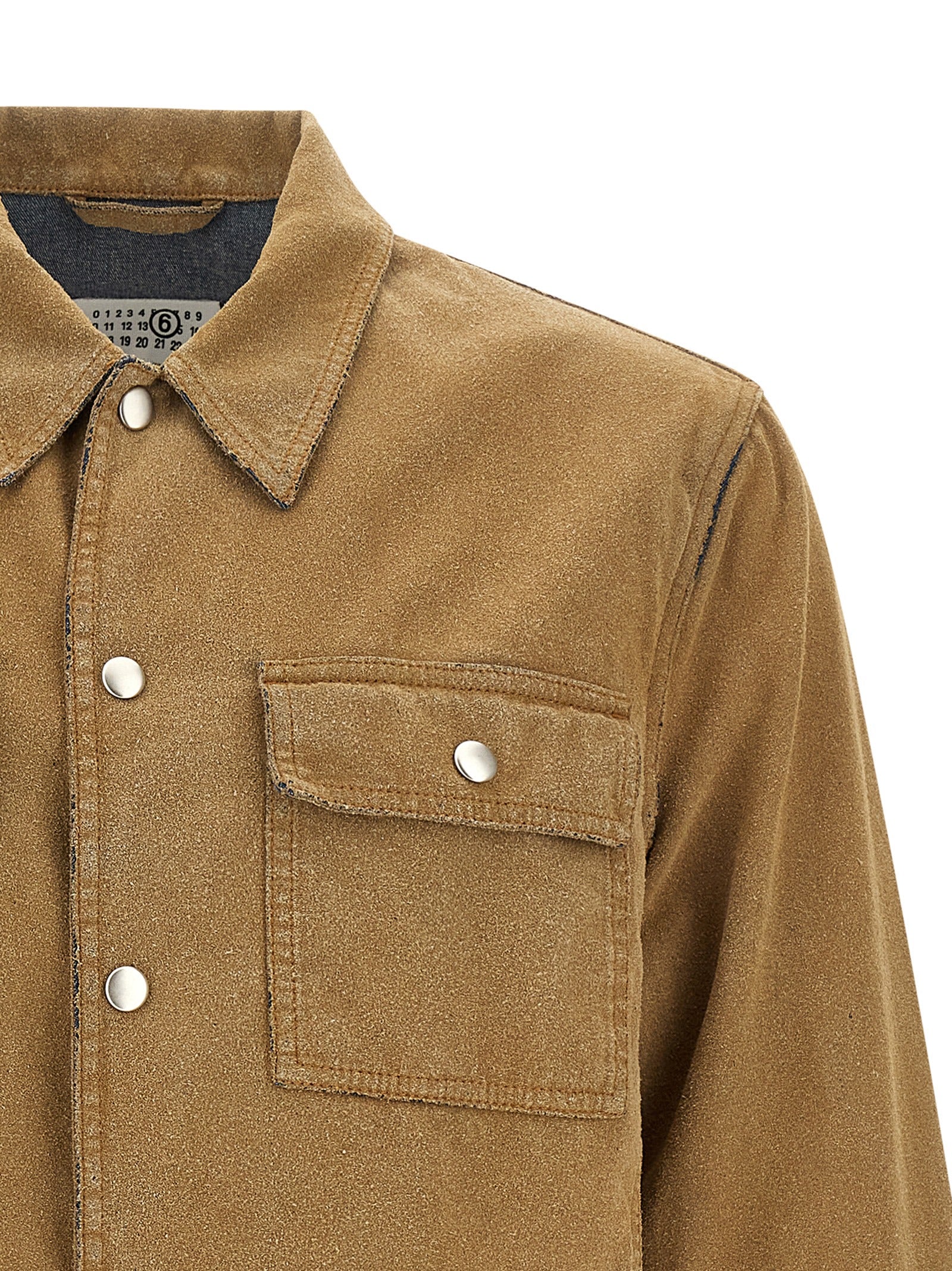 Elevate your wardrobe with the MM6 Maison Margiela Beige Cotton Denim Jacket, a masterpiece of artisanal luxury that seamlessly blends sophistication and modernity.
