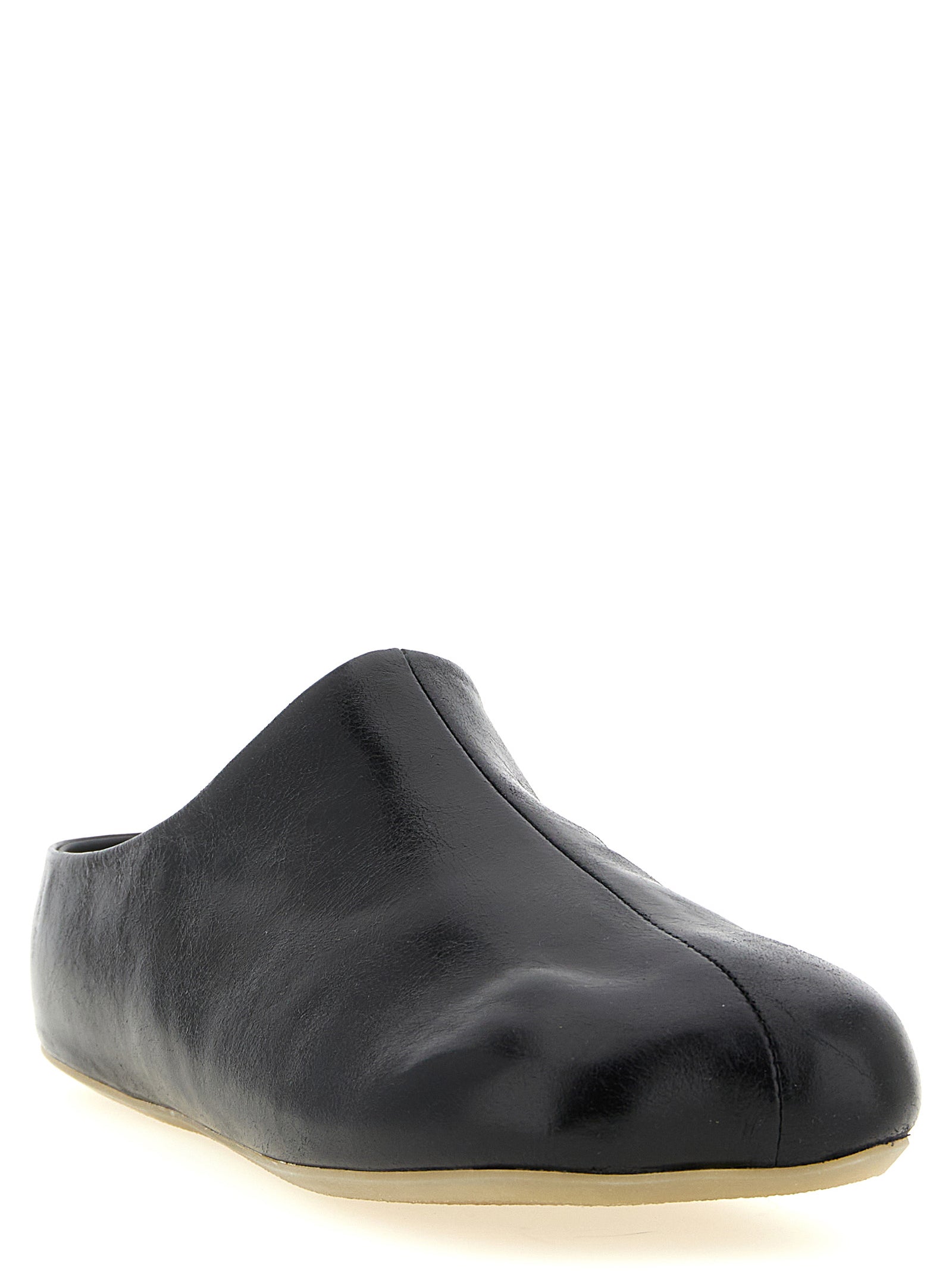 Experience the exquisite MM6 Maison Margiela Black Calfskin Clogs, where artisanal luxury meets avant-garde design, elevating your style with every step.
