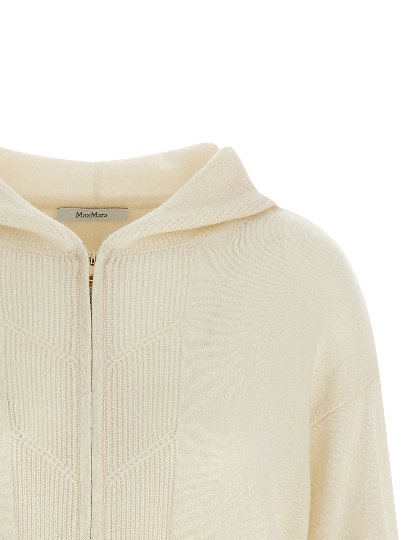 Experience the exquisite allure of the Max Mara White Cashmere Cardigan, a luxurious essential crafted from pure cashmere, redefining elegance and sophistication.