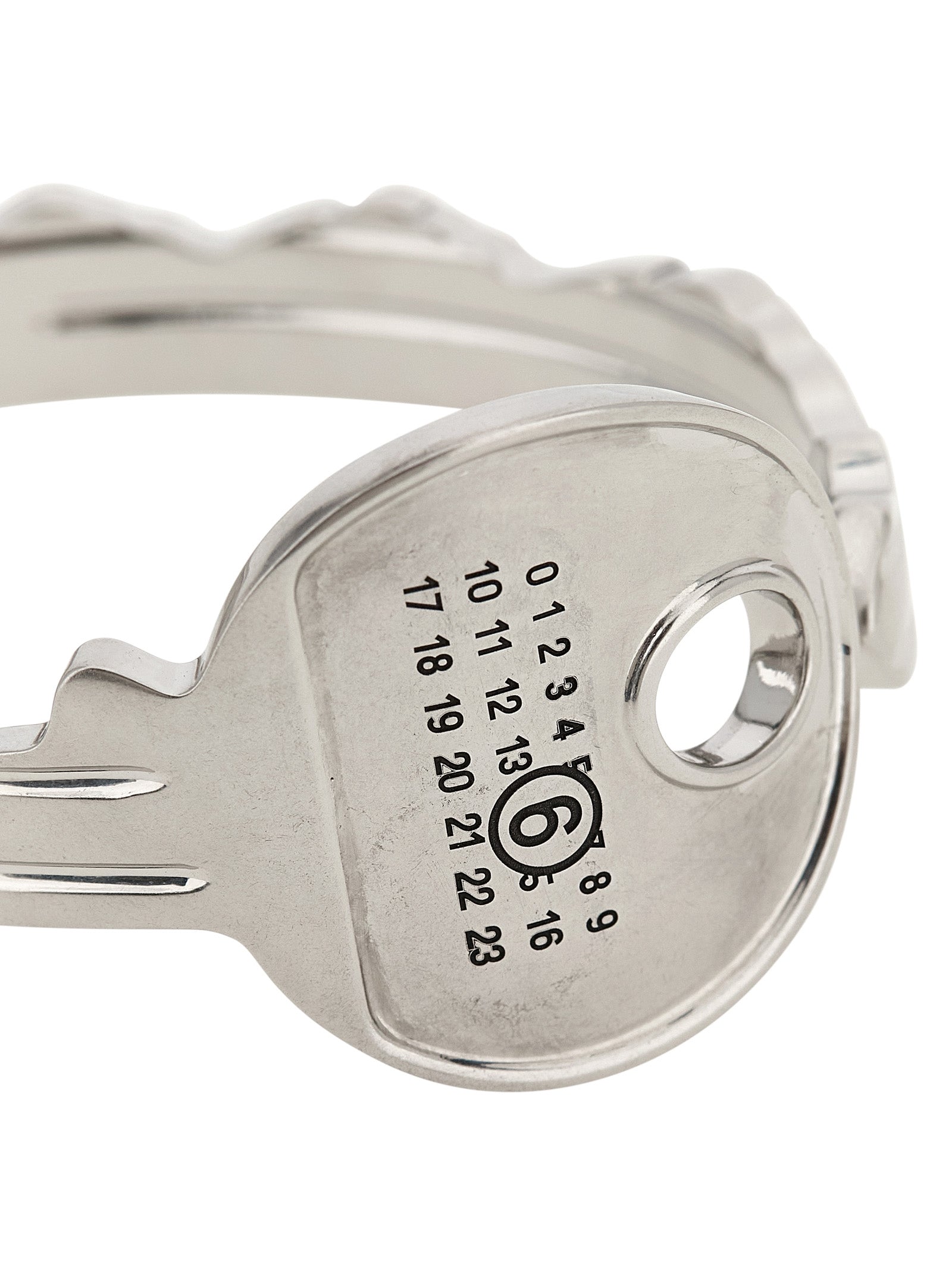 Discover the MM6 Maison Margiela Silver Brass Bracelet, an artisanal key-shaped bangle that embodies modern elegance and sophisticated craftsmanship.