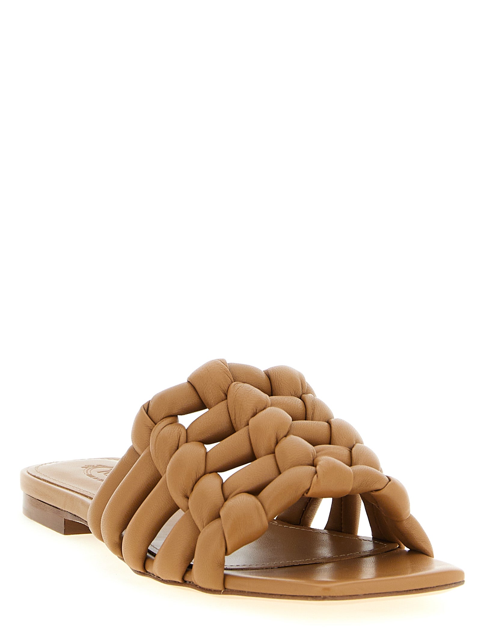 Experience the exquisite allure of Tod's Brown Lambskin Slides, crafted from 100% sheepskin leather, merging Italian craftsmanship with timeless elegance for the discerning individual.