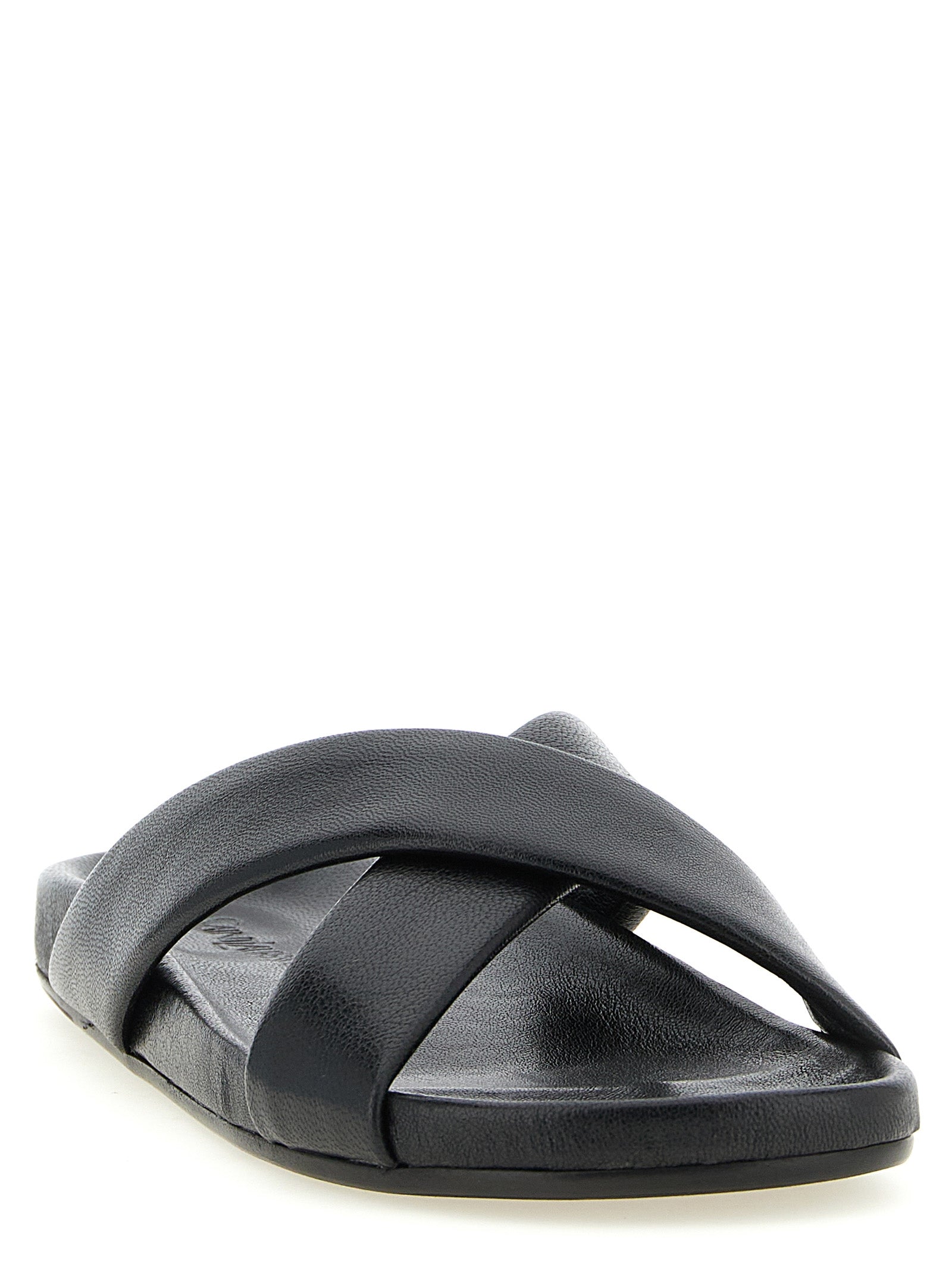 Experience the elegance of Saint Laurent Black Lamb Leather Slides, handcrafted in Italy from luxurious lamb leather, embodying timeless sophistication and effortless style.