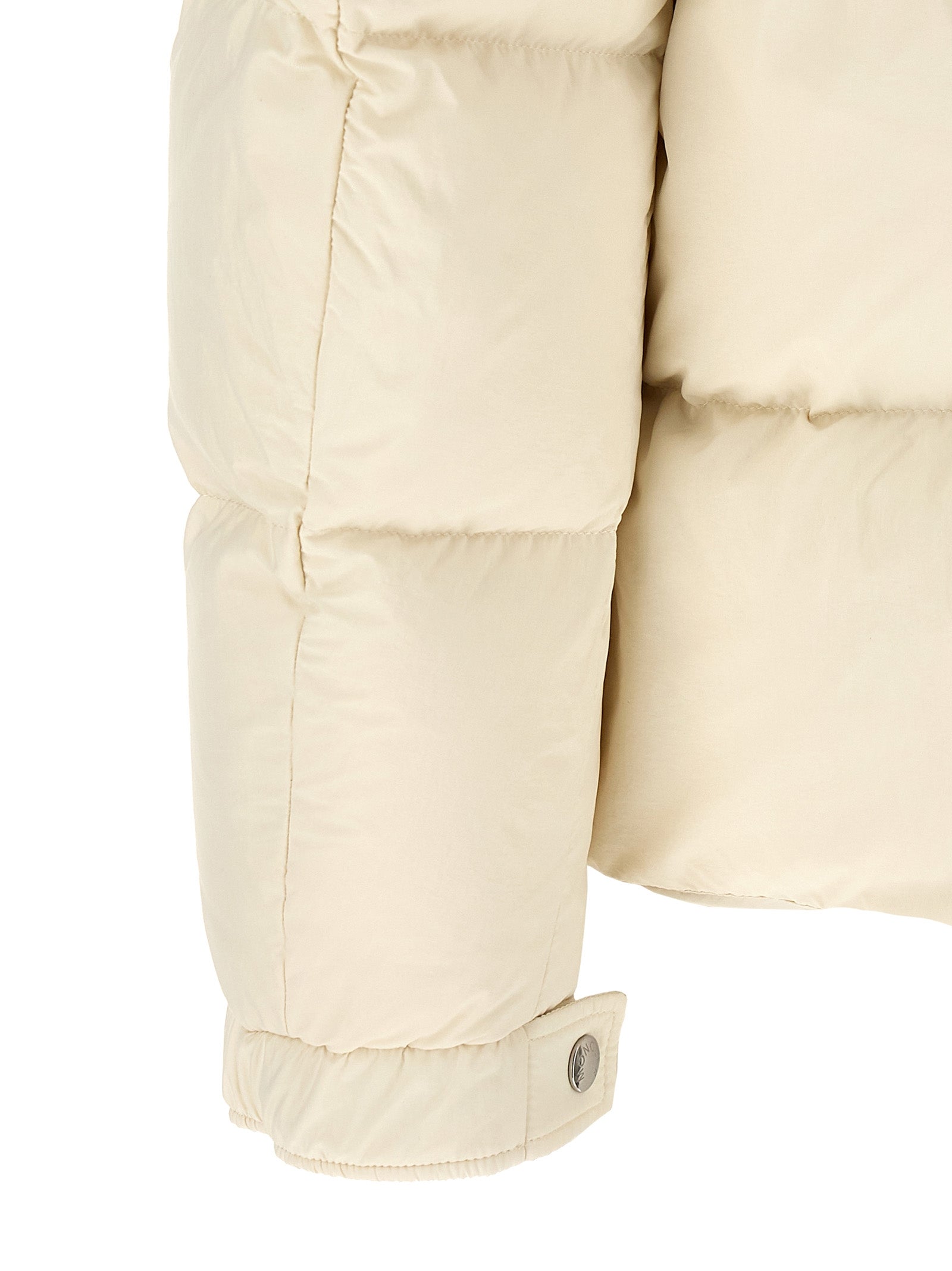 Indulge in the Moncler Beige Polyamide Full-Length Jacket, a masterpiece of quilted nylon and goose down, embodying luxury and sophistication for every occasion.