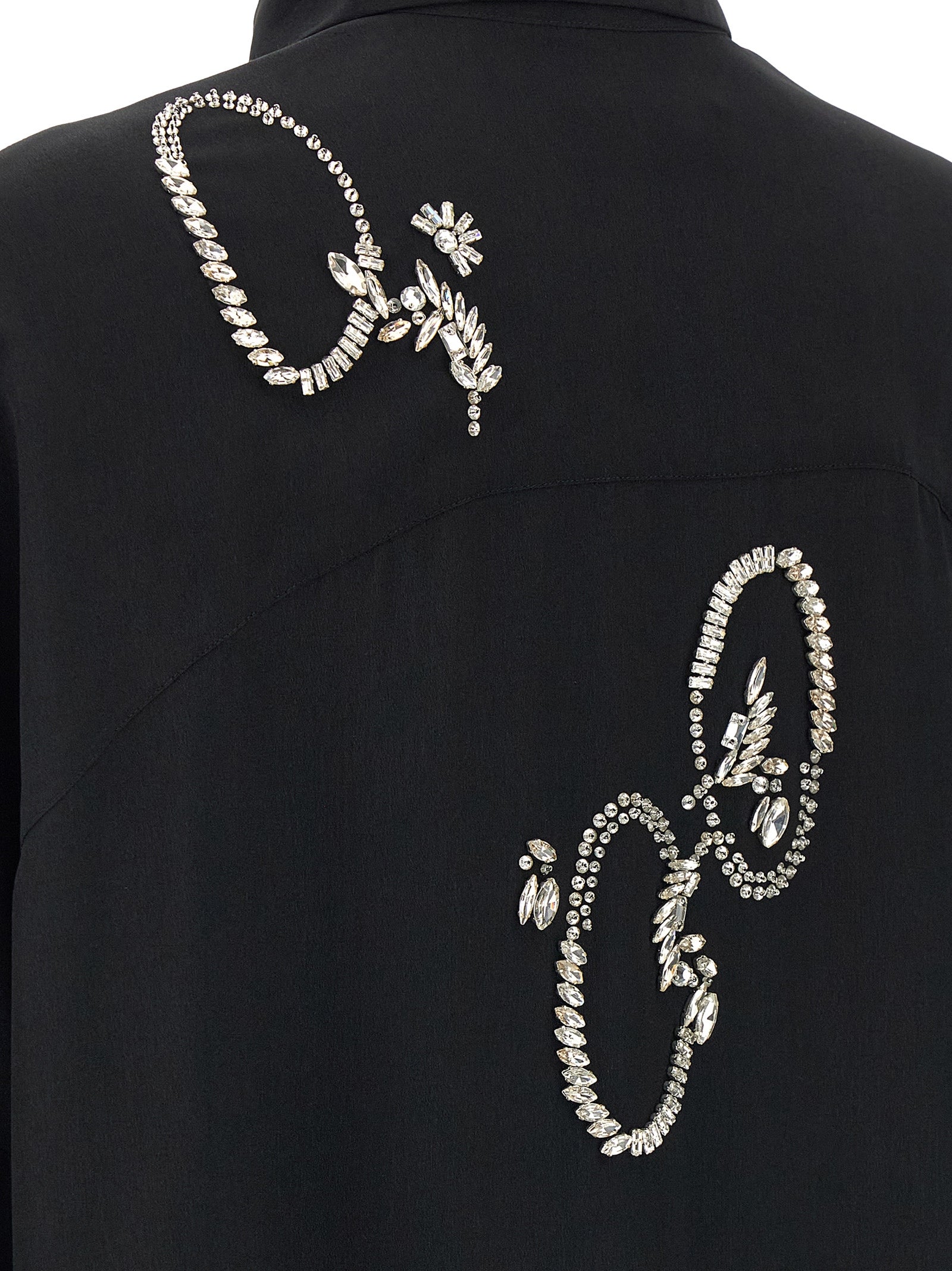 Discover the Dries Van Noten Black Polyester Blouse, a masterpiece of elegance adorned with crystal appliqué, perfect for those who embrace luxury and sophistication.
