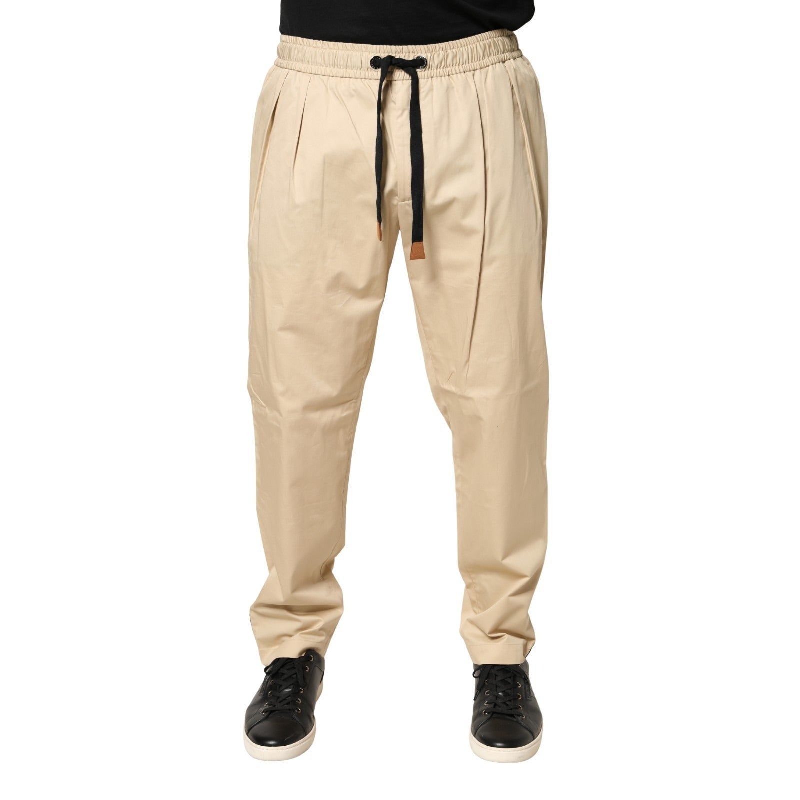 Indulge in the elegance of Dolce & Gabbana's beige cotton skinny jogger trousers, where Italian craftsmanship meets refined luxury for the discerning individual.