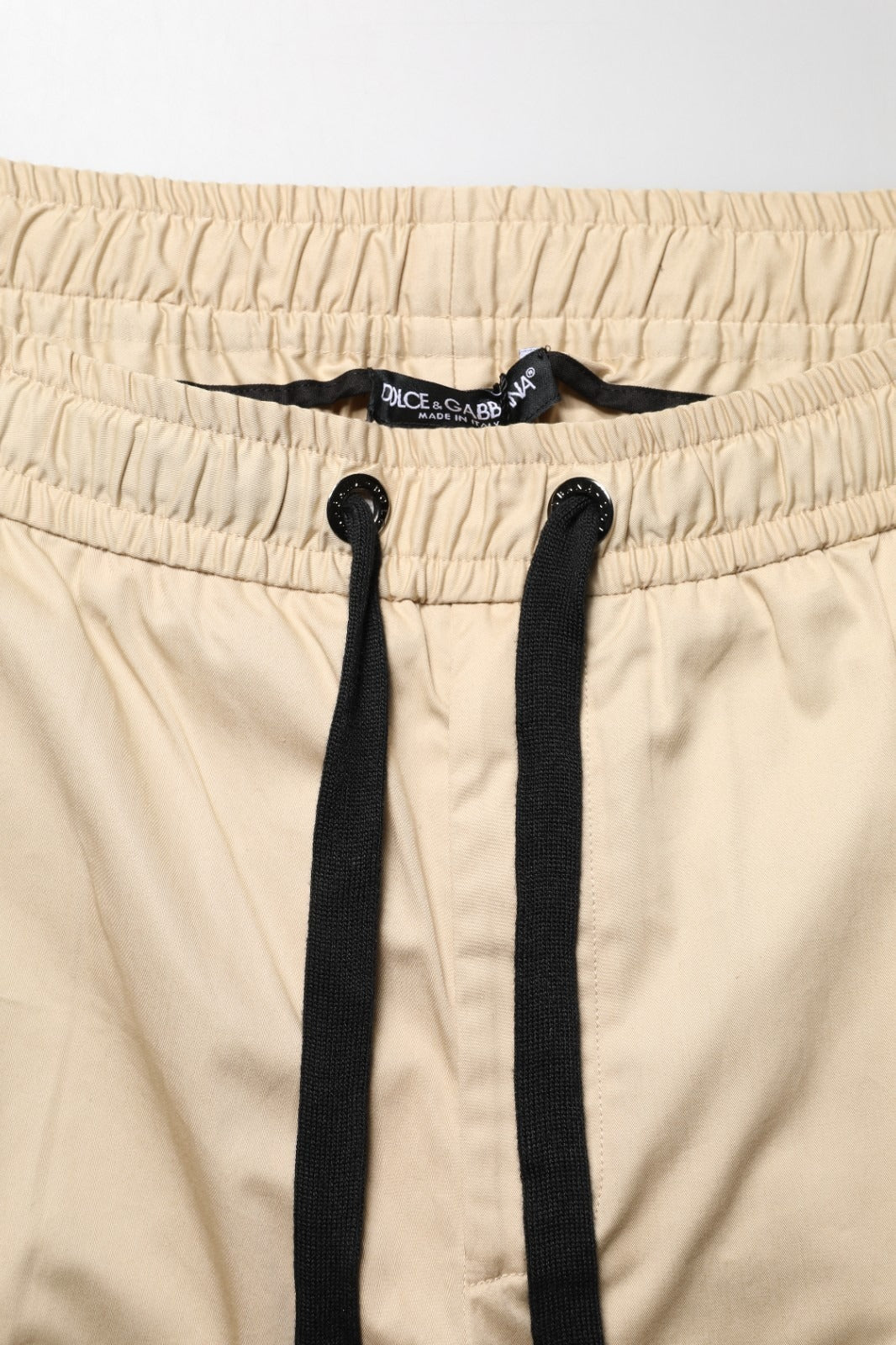 Indulge in the elegance of Dolce & Gabbana's beige cotton skinny jogger trousers, a luxurious blend of comfort and Italian craftsmanship for the discerning individual.
