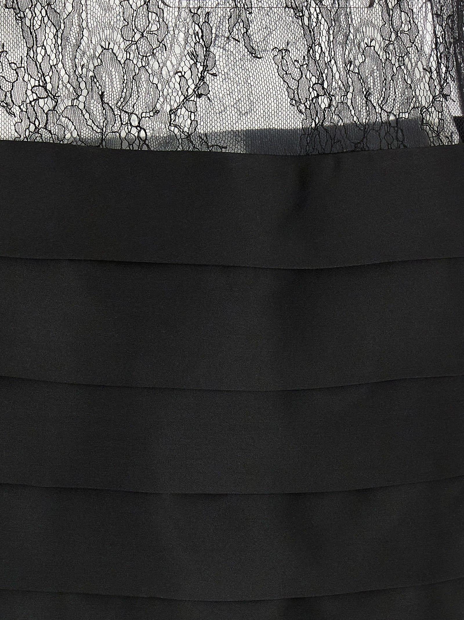 Experience the allure of the Ferragamo Black Silk Mini Dress, a masterpiece of Italian craftsmanship, blending luxurious silk with exquisite design for unforgettable elegance.