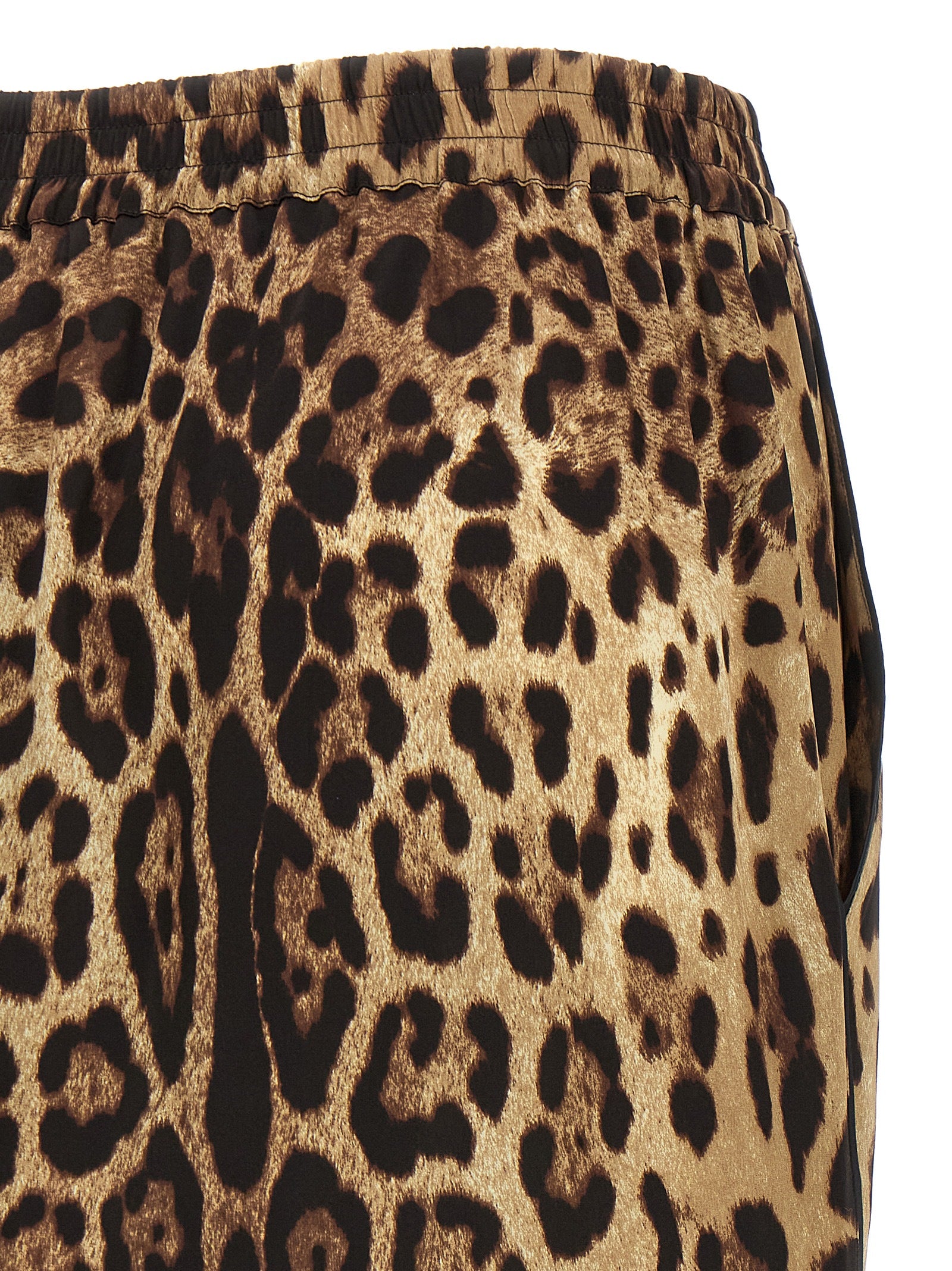Indulge in the exquisite Dolce & Gabbana Brown Silk Bermuda Shorts, where luxurious silk meets daring leopard print, embodying timeless elegance and effortless sophistication.
