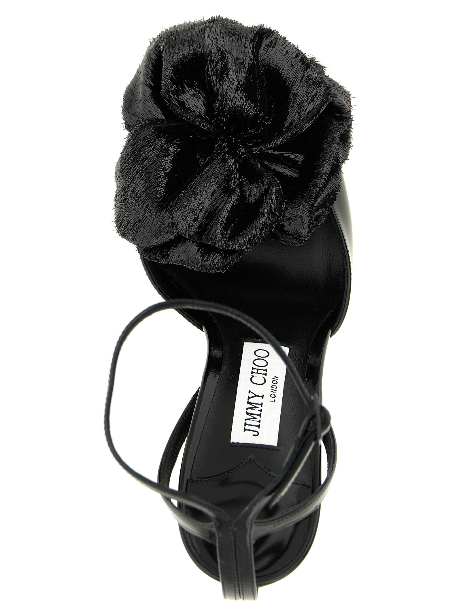 Indulge in the exquisite craftsmanship of Jimmy Choo's Mimmi sandals, featuring lustrous black leather and a stunning 3D floral detail, perfect for elevating any elegant ensemble.